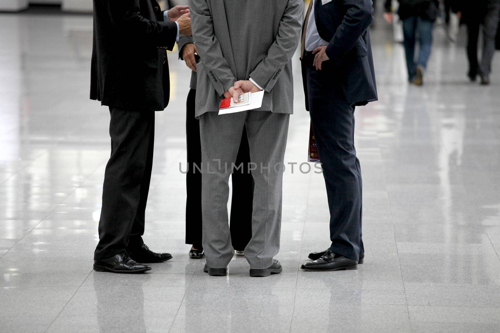 Four businessmen are negotiating in a circle by BEMPhoto