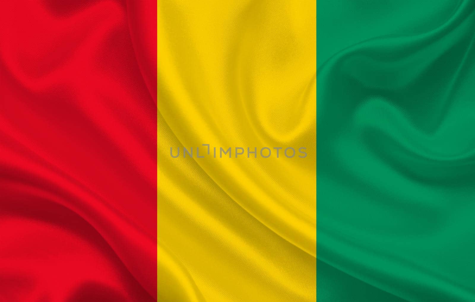 Guinea country flag on wavy silk fabric background panorama by BEMPhoto