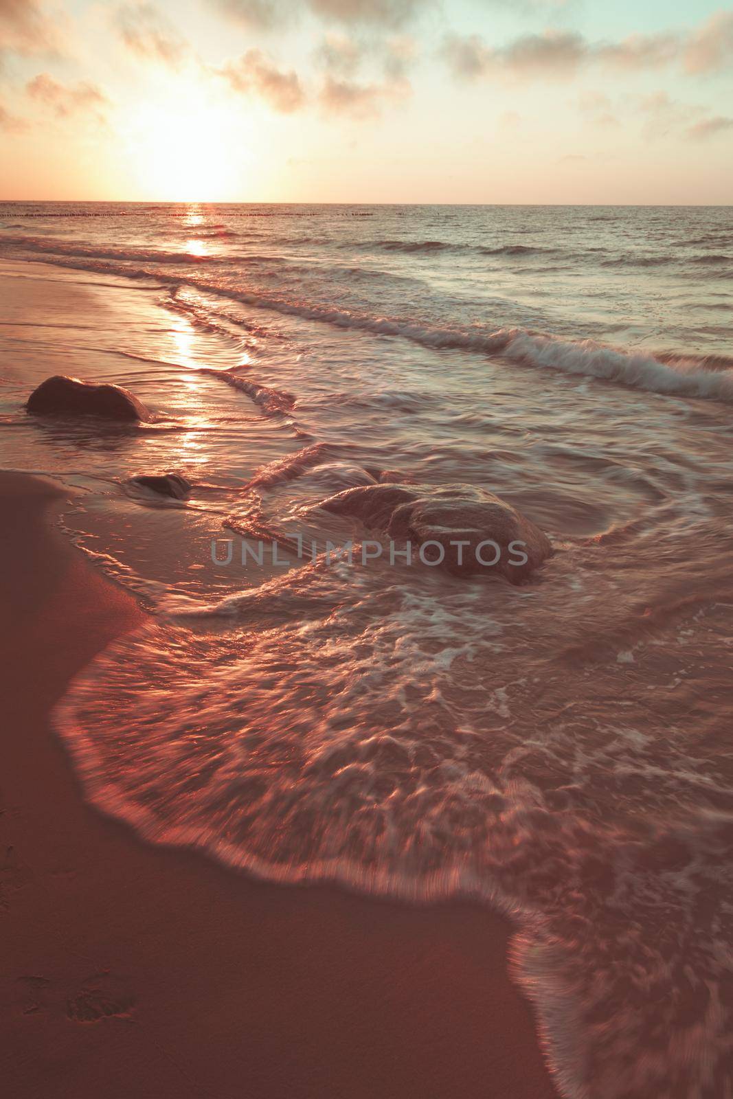 The sun sets over the sea horizon. High quality photo