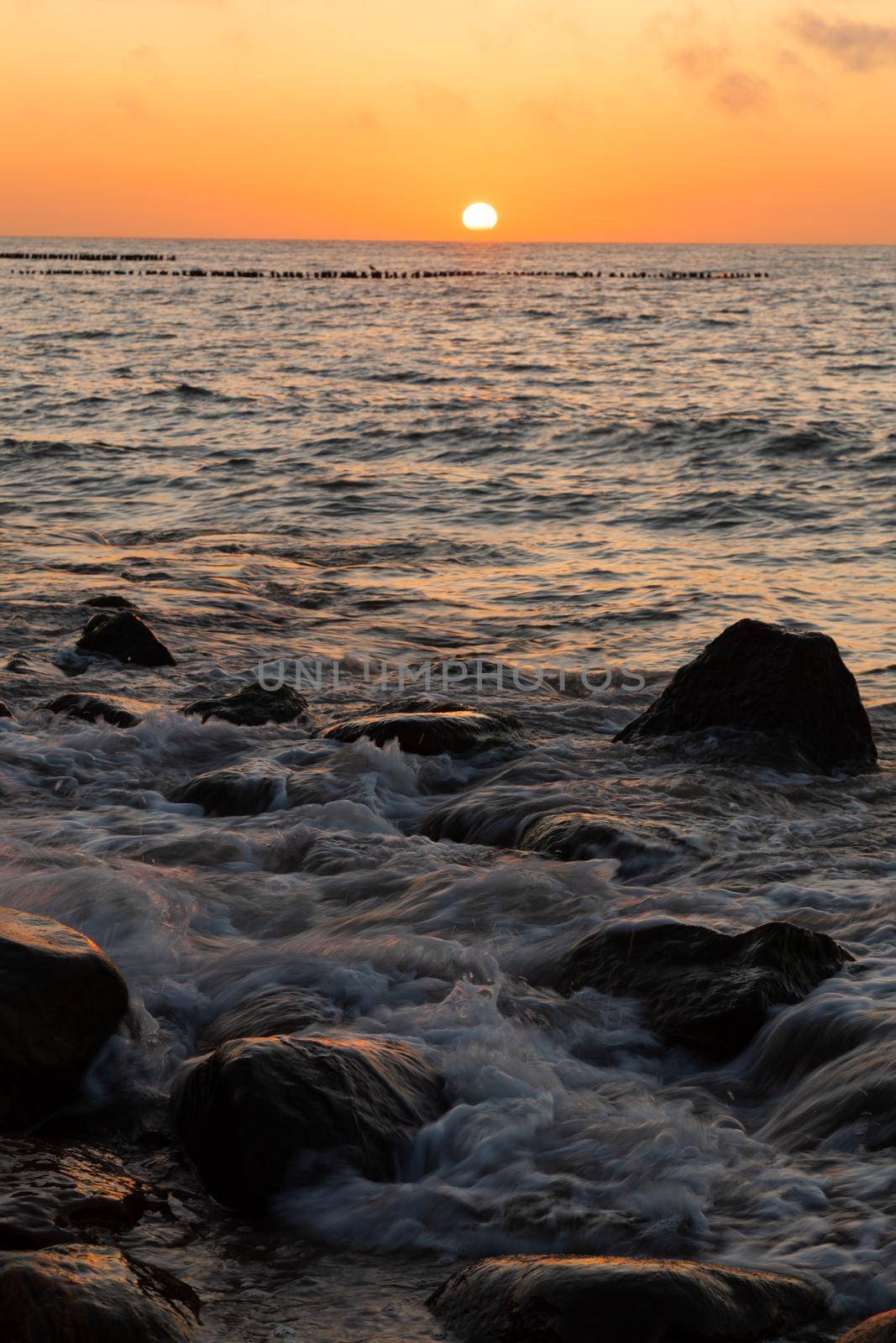 The sun sets over the sea horizon. High quality photo