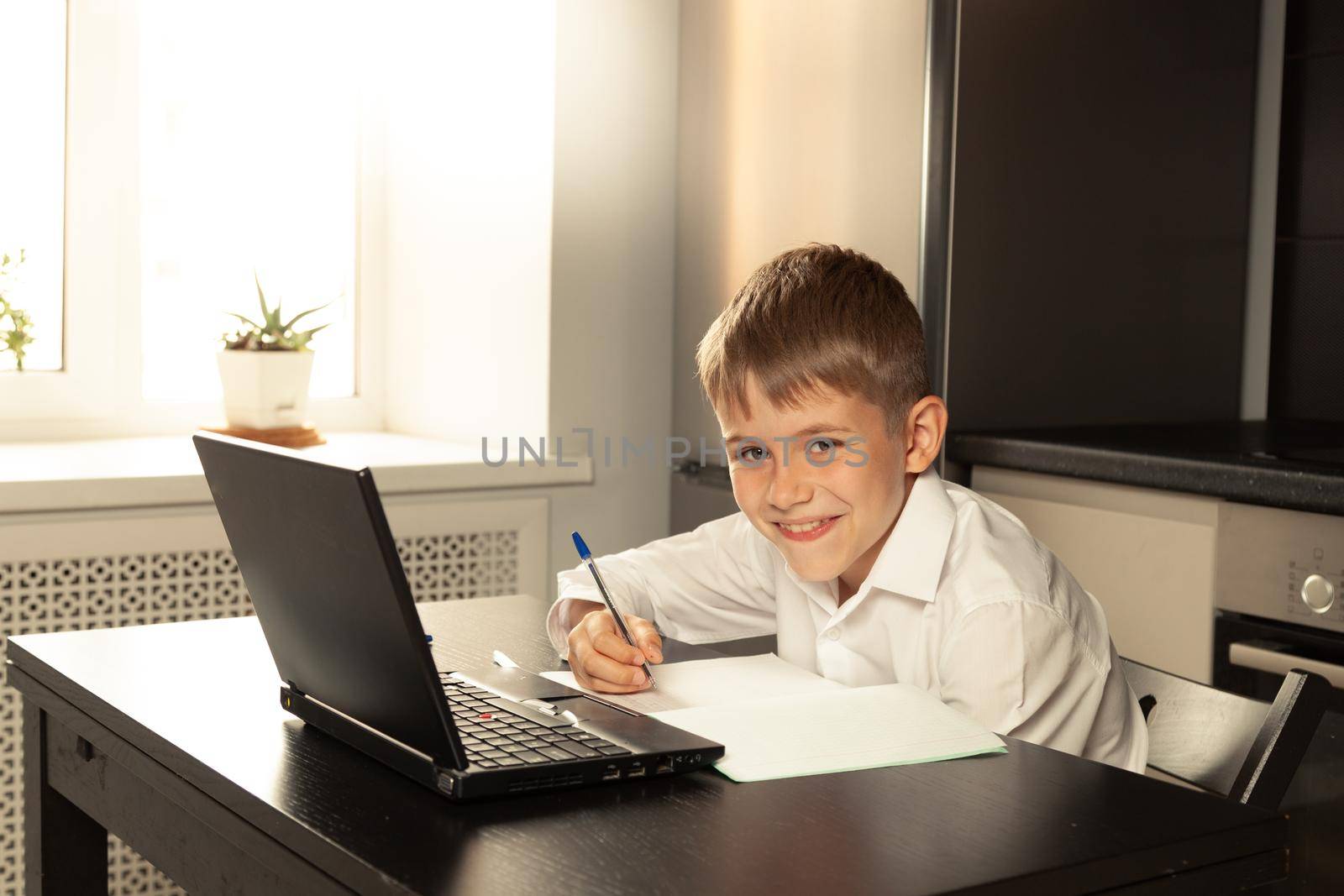 The child is happy about the new school year. Remote lesson at school. Back to school