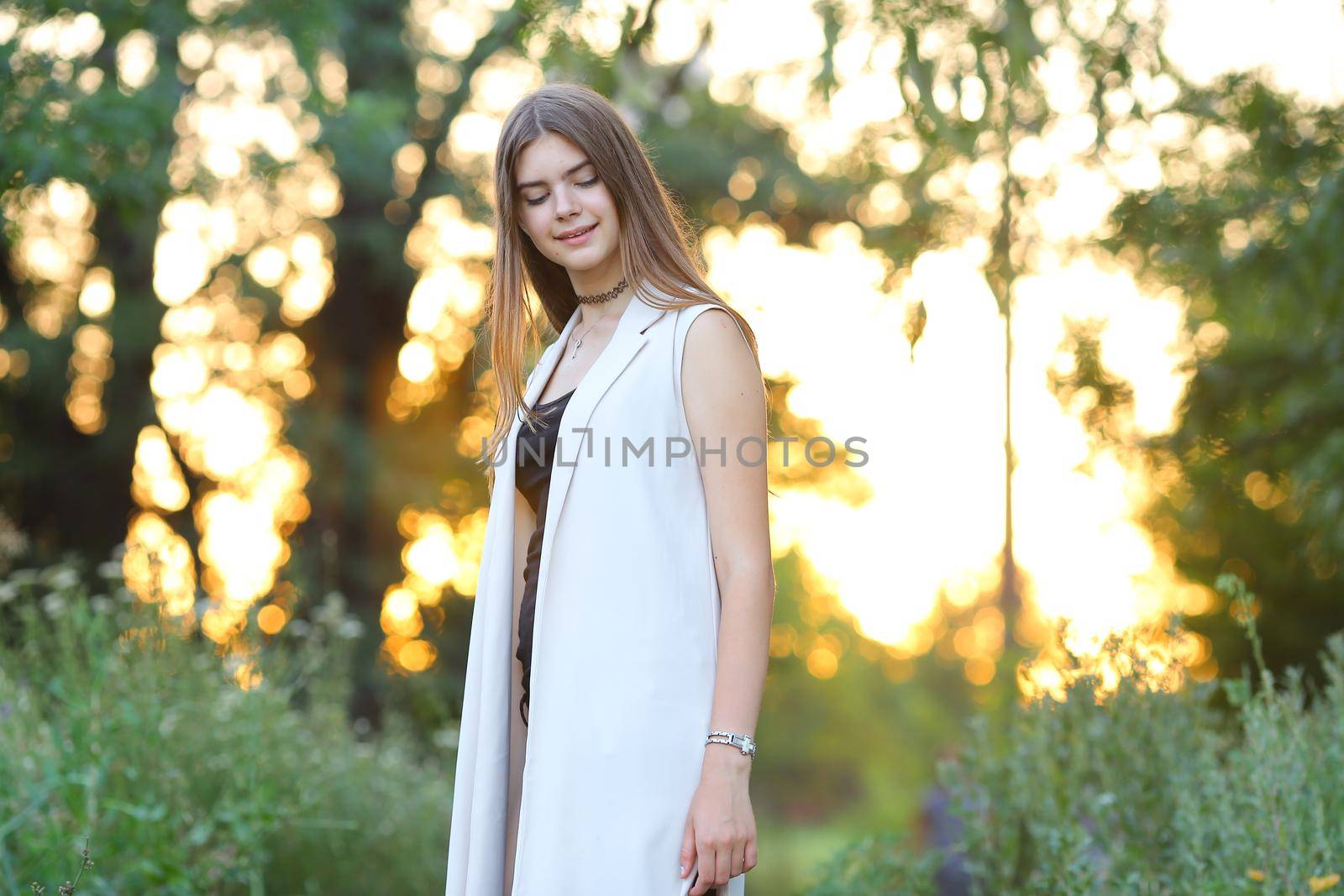 Woman with long hair and beautiful eyes on a green background shows the different human emotions. Lady portrays joy, lightness, ease, delight