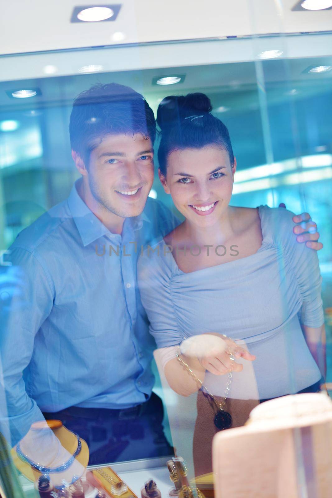 happy young romantic couple in love buy jewelry ring in luxury store