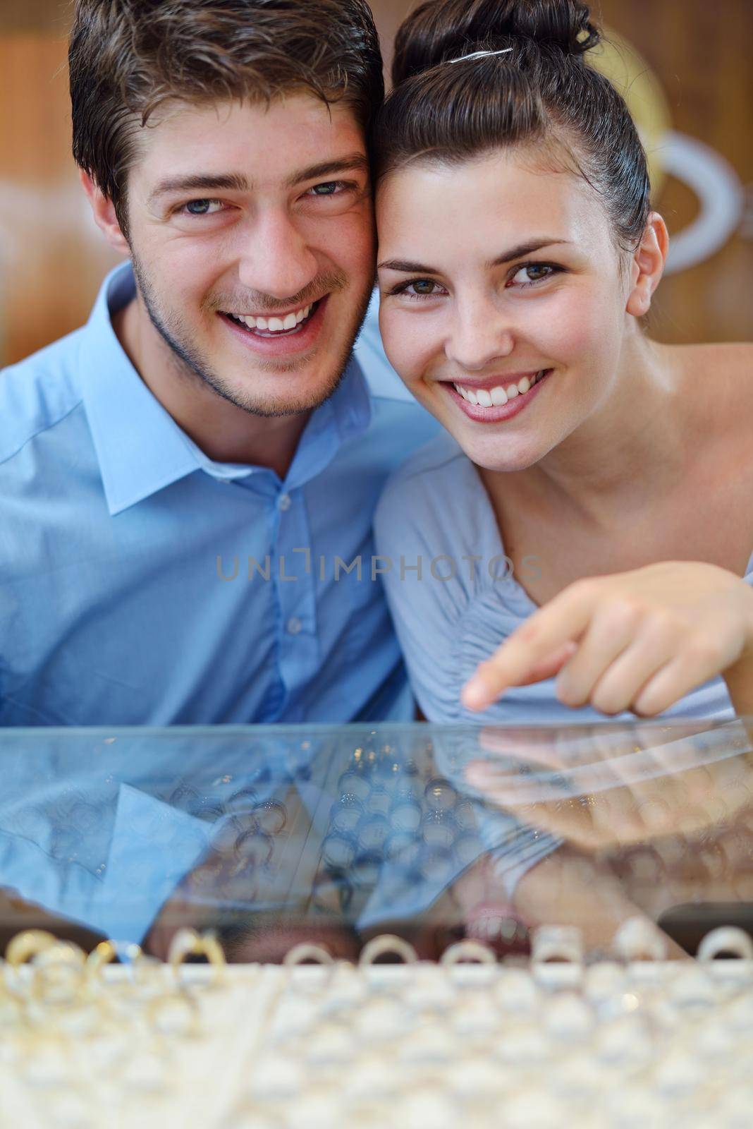 happy young romantic couple in love buy jewelry ring in luxury store