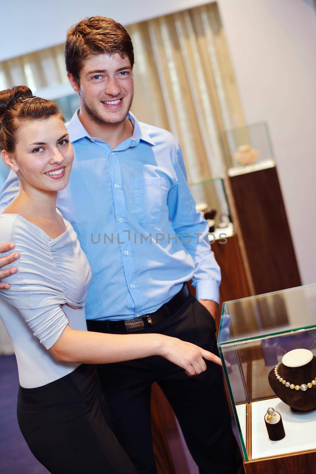 happy young romantic couple in love buy jewelry ring in luxury store