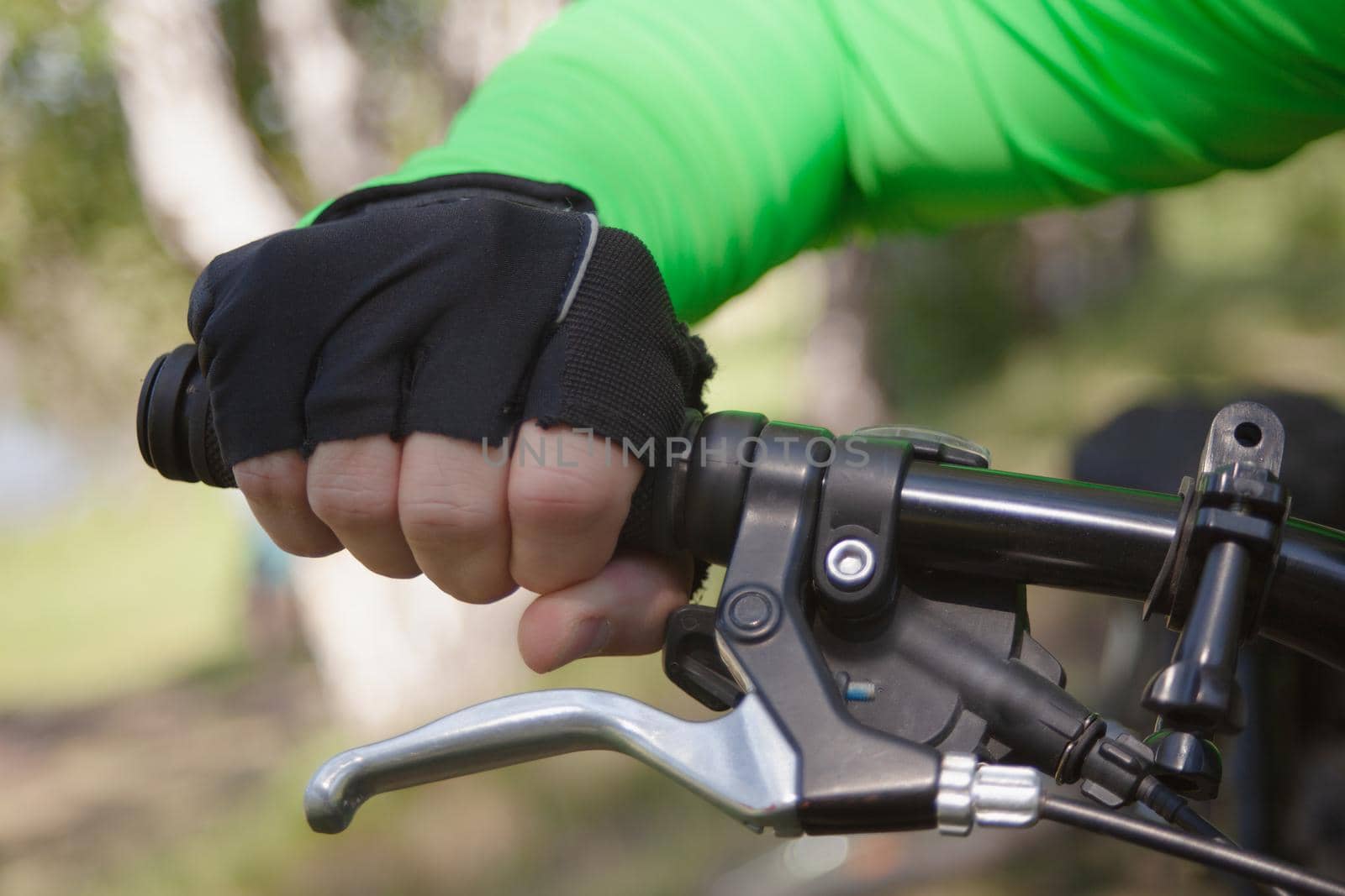 A gloved hand holds the handlebars firmly. High quality photo