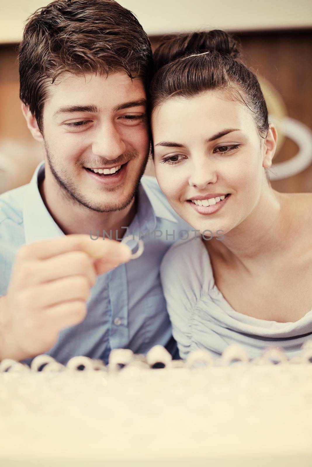 happy young romantic couple in love buy jewelry ring in luxury store