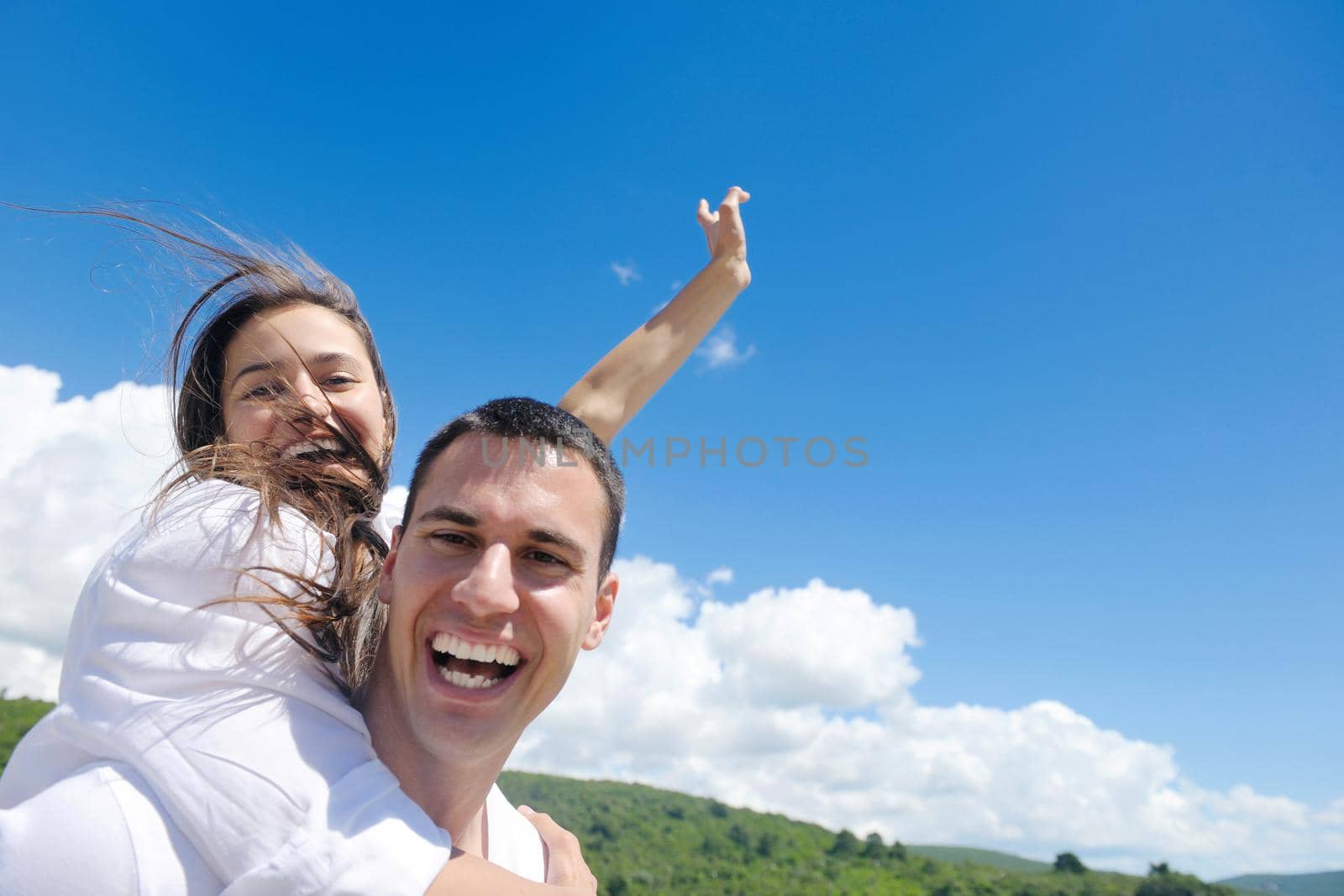 happy young couple have fun and relax  on the beach