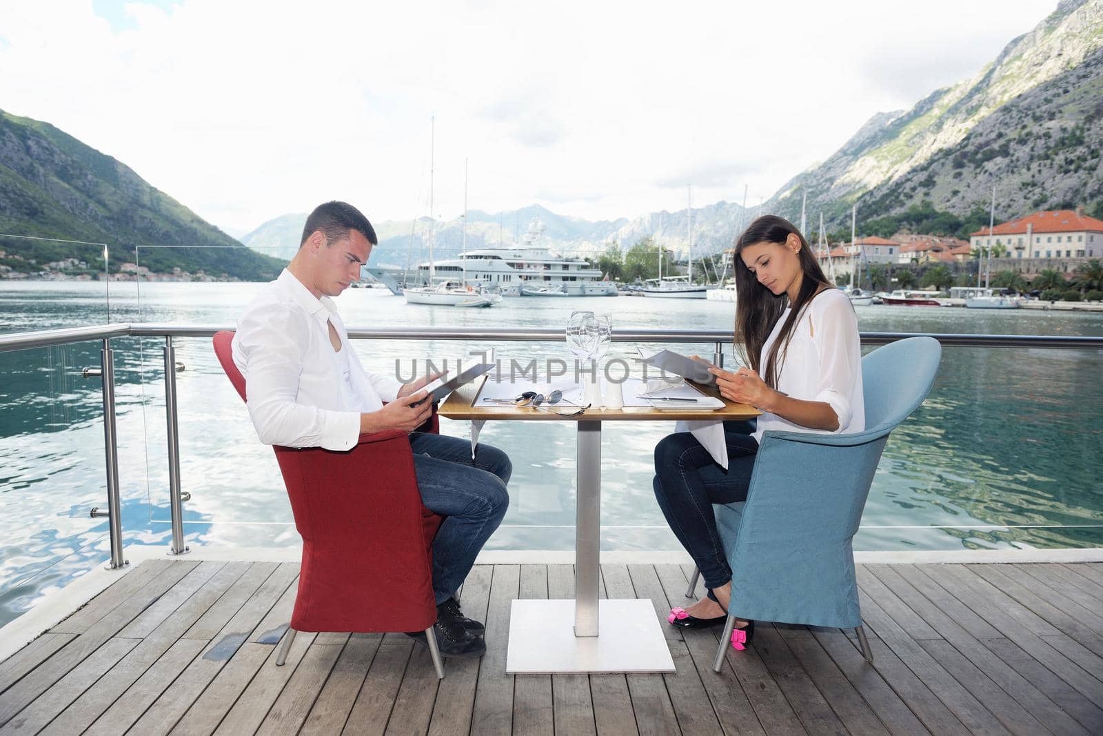 happy young couple having lanch at beautiful restaurant on by the sea on  beach