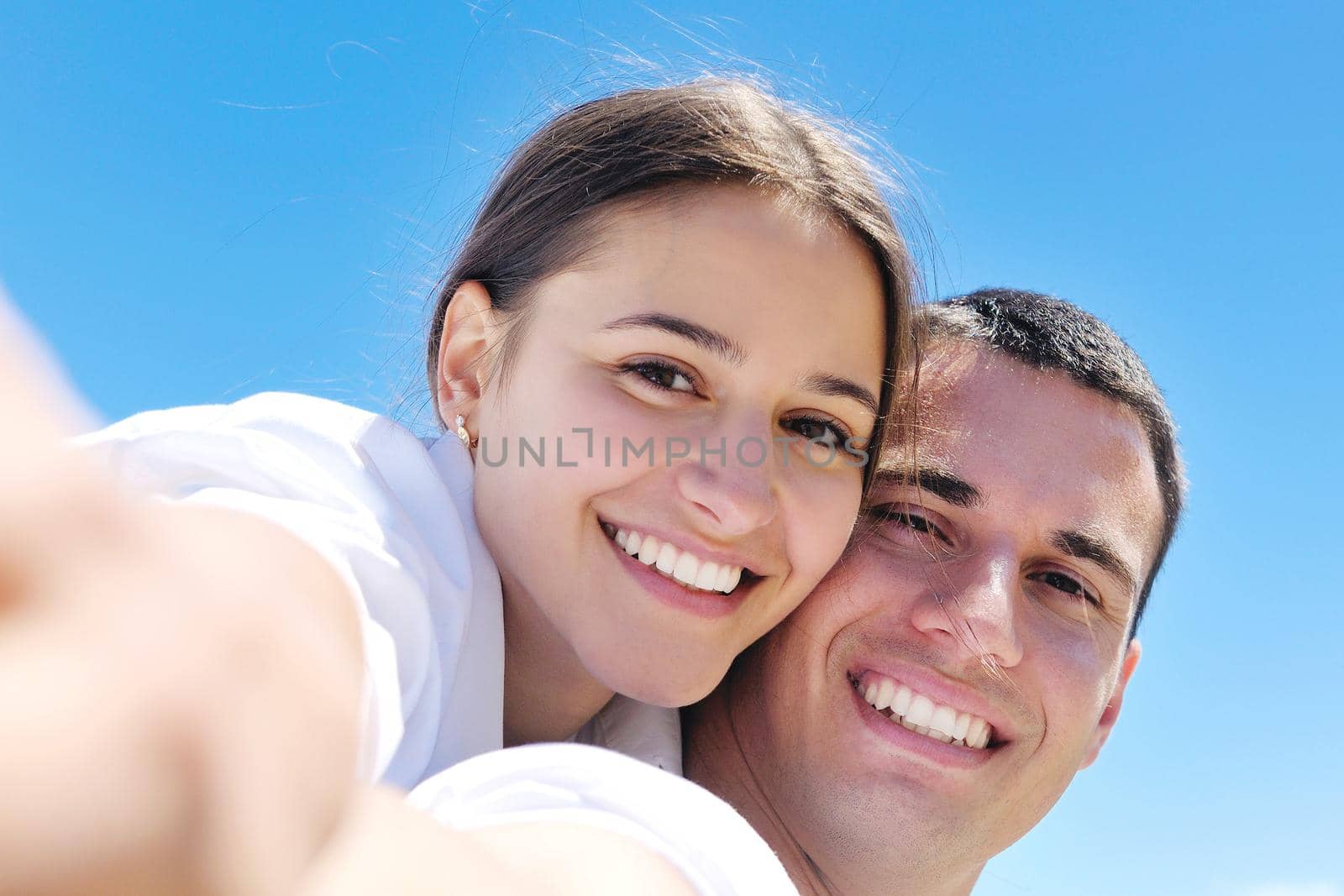 happy young couple have fun and relax  on the beach