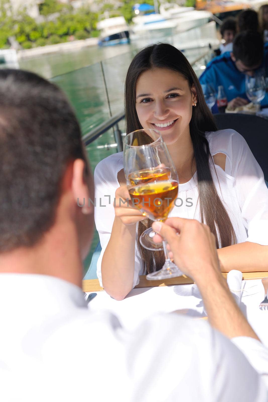 happy young couple having lanch at beautiful restaurant on the beach