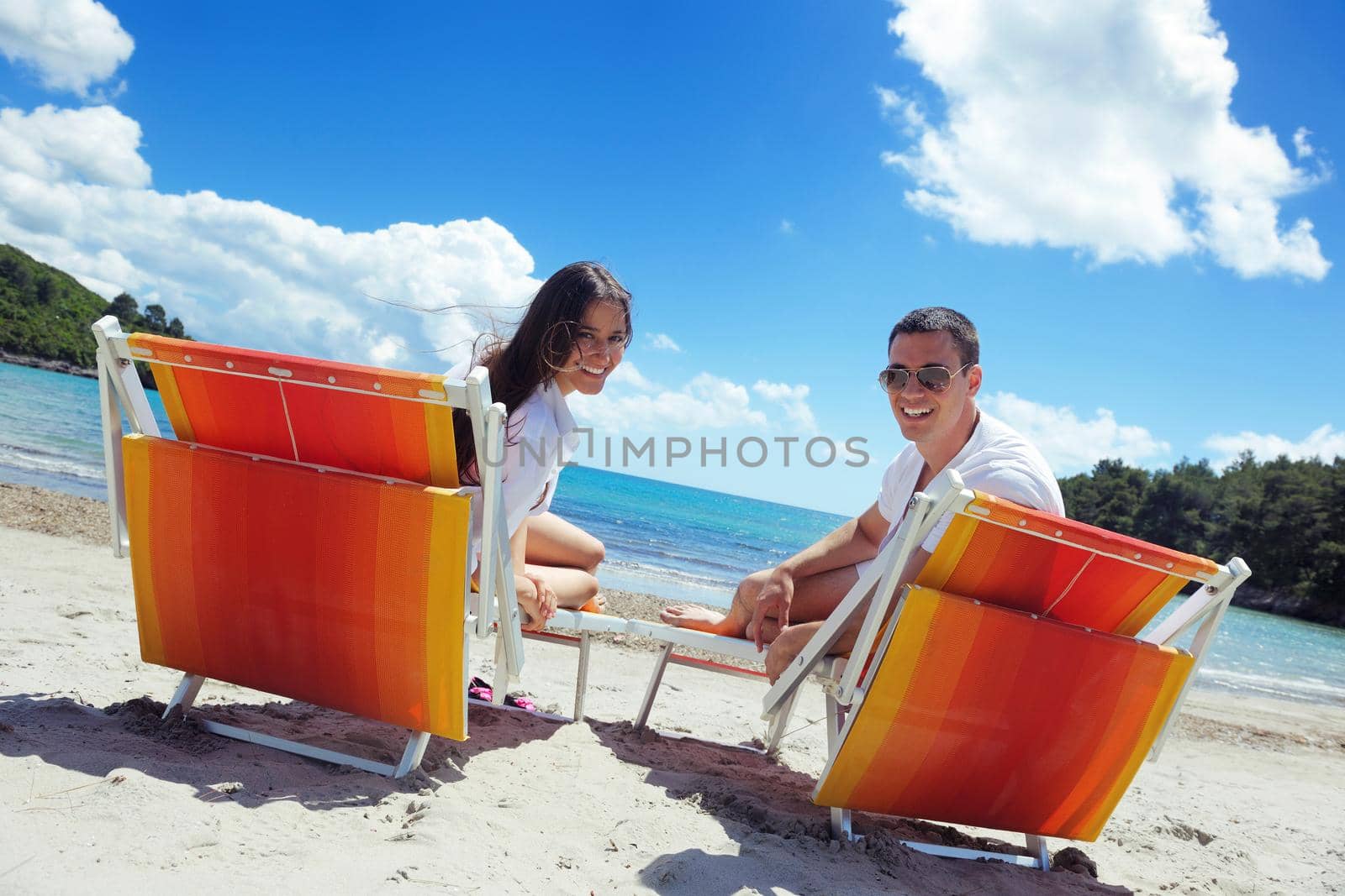 happy young couple have fun and relax  on the beach