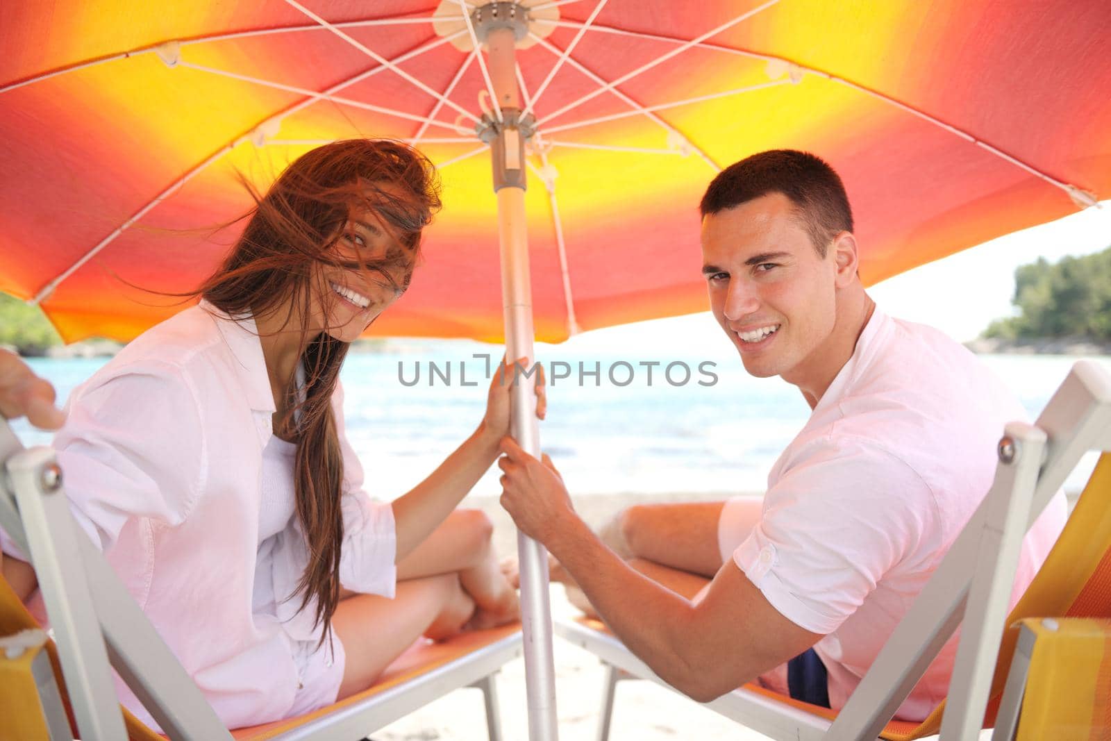 happy young couple have fun and relax  on the beach