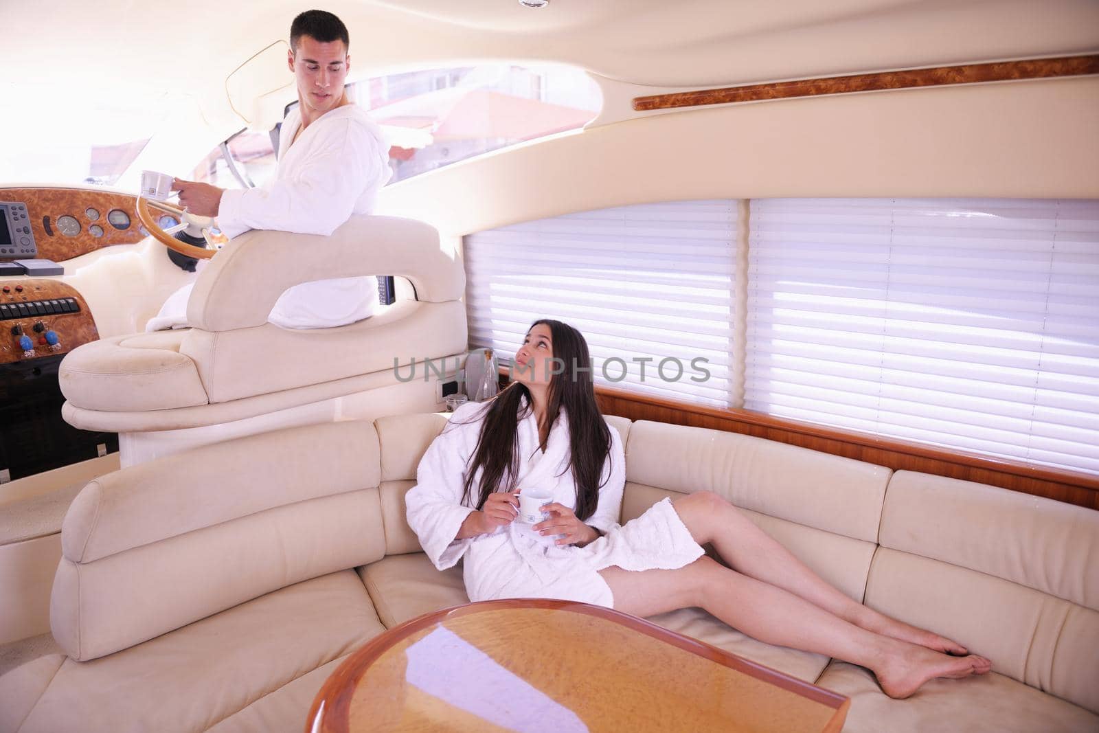 Romantic young couple spending time together and relaxing on yacht