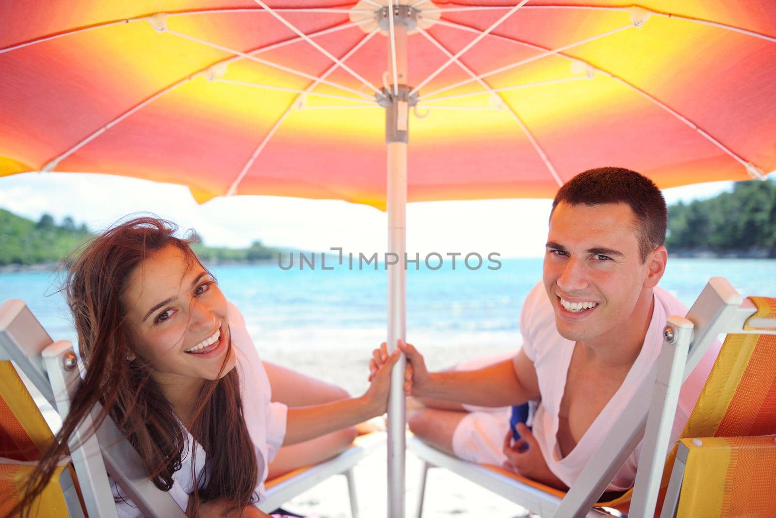 happy couple have fun on the beach by dotshock