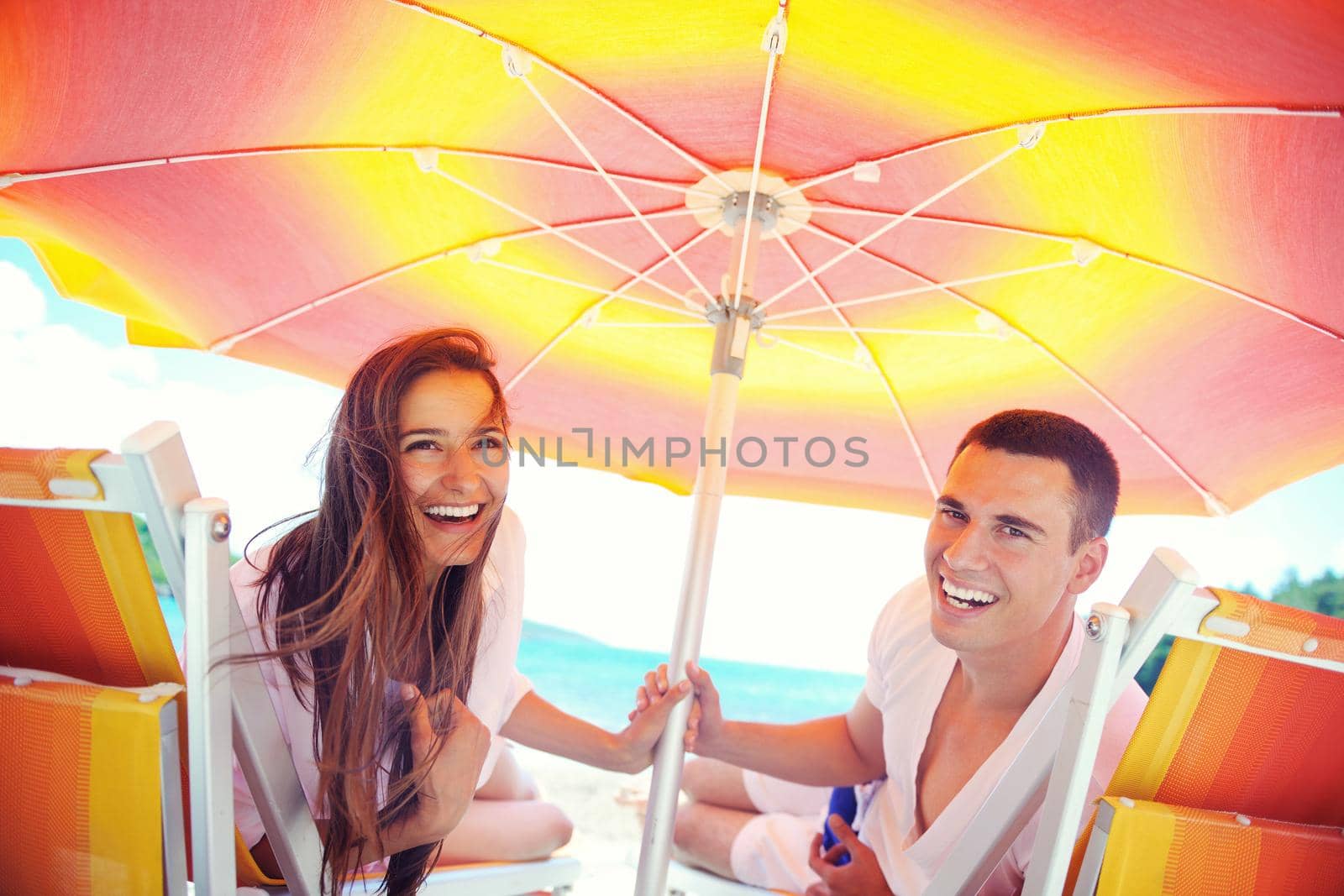 happy young couple have fun and relax  on the beach