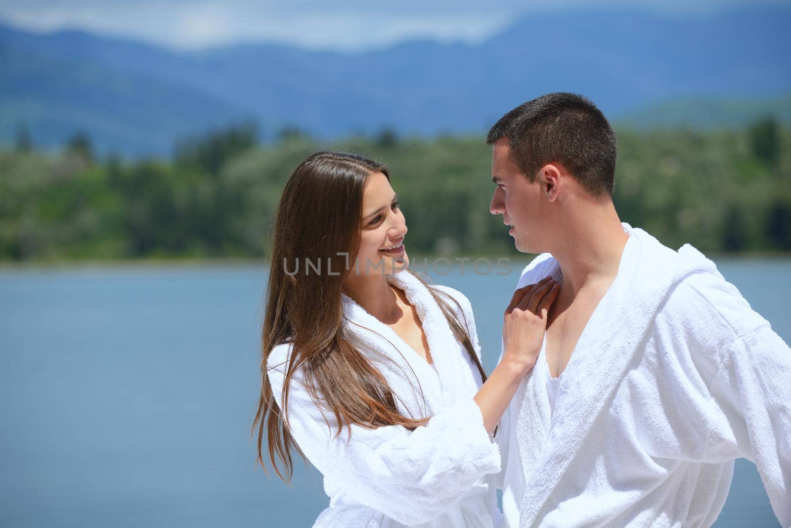 Romantic young couple spending time together and relaxing on yacht