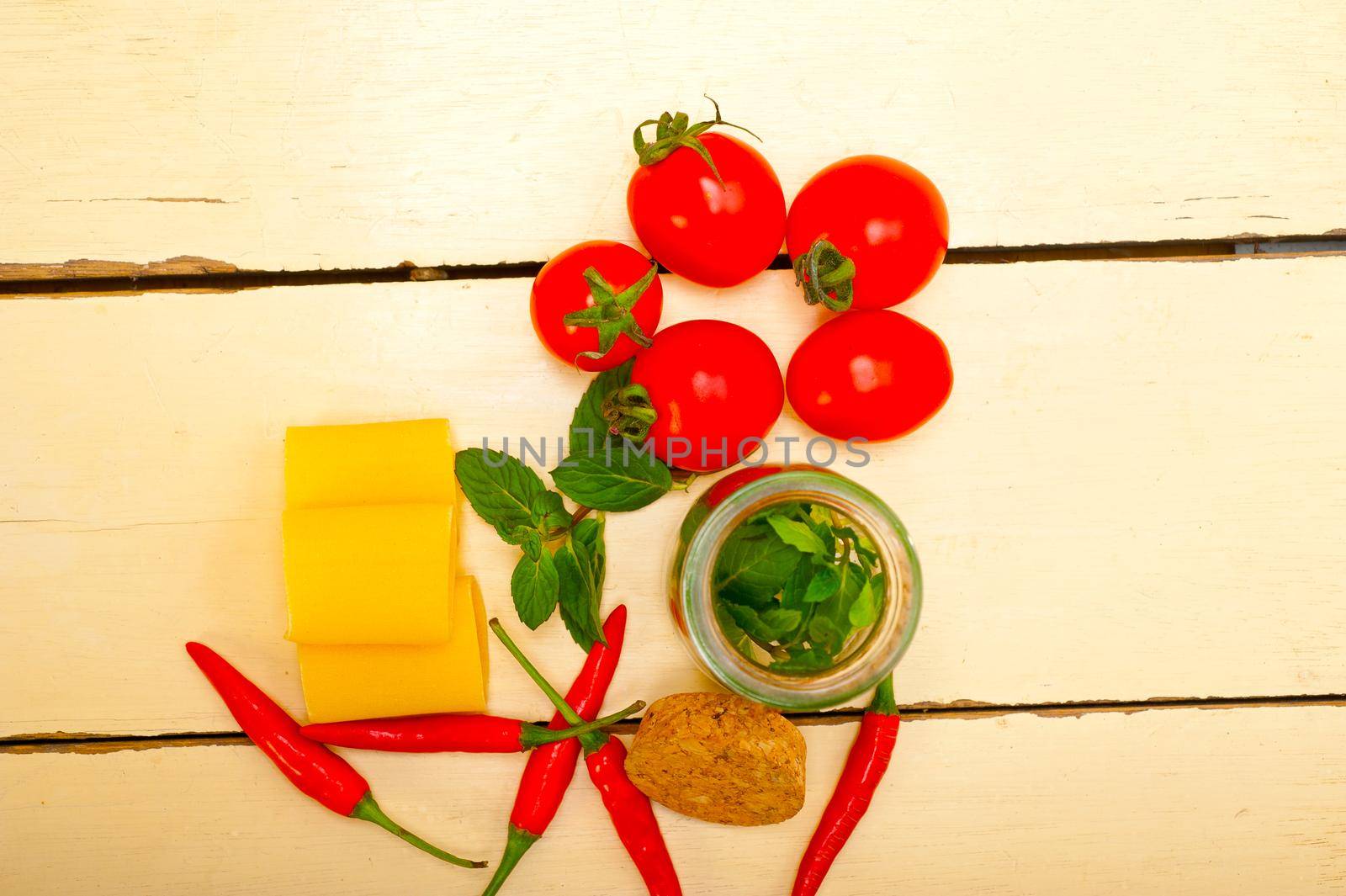 Italian pasta paccheri or schiaffoni with tomato mint and chili pepper ingredients