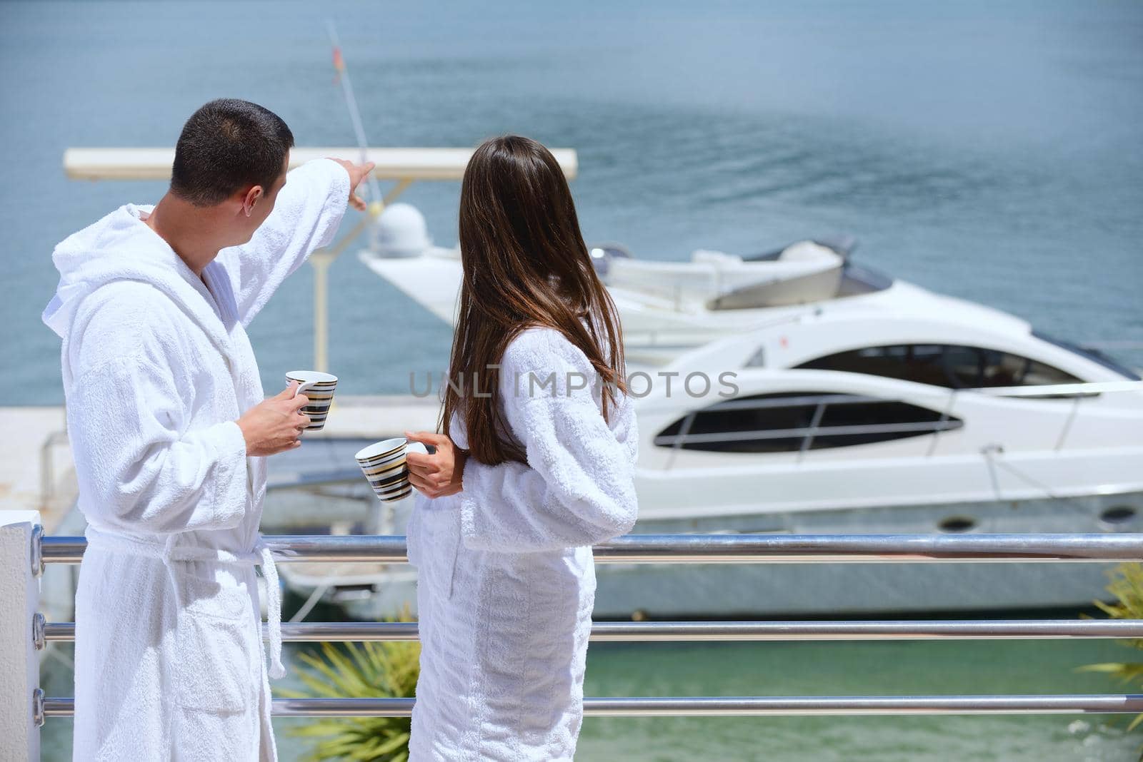 Romantic young couple spending time together and relaxing on yacht