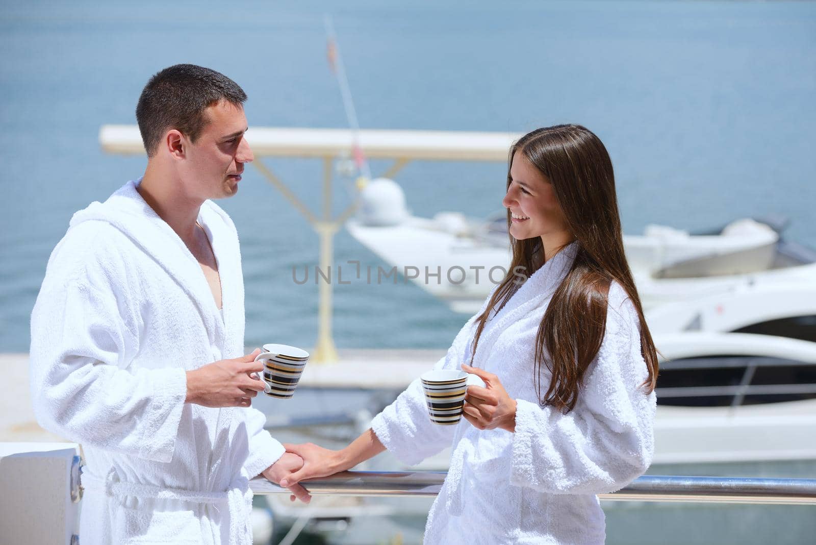 Romantic young couple spending time together and relaxing on yacht