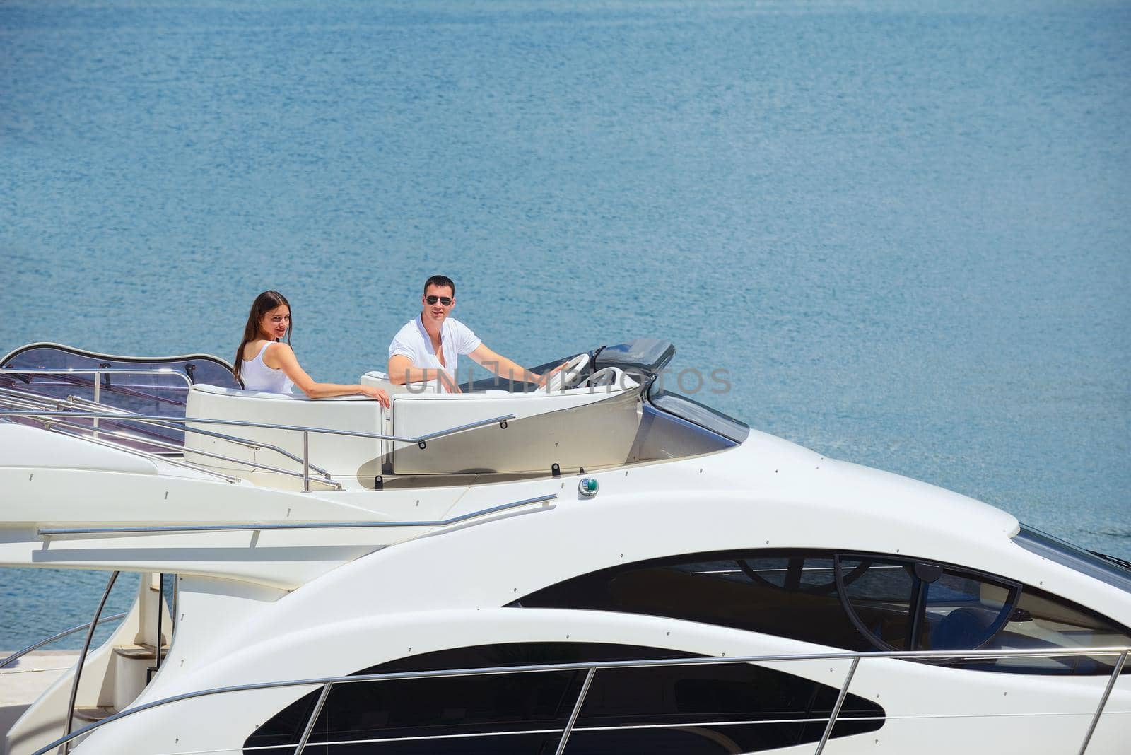 Romantic young couple spending time together and relaxing on yacht