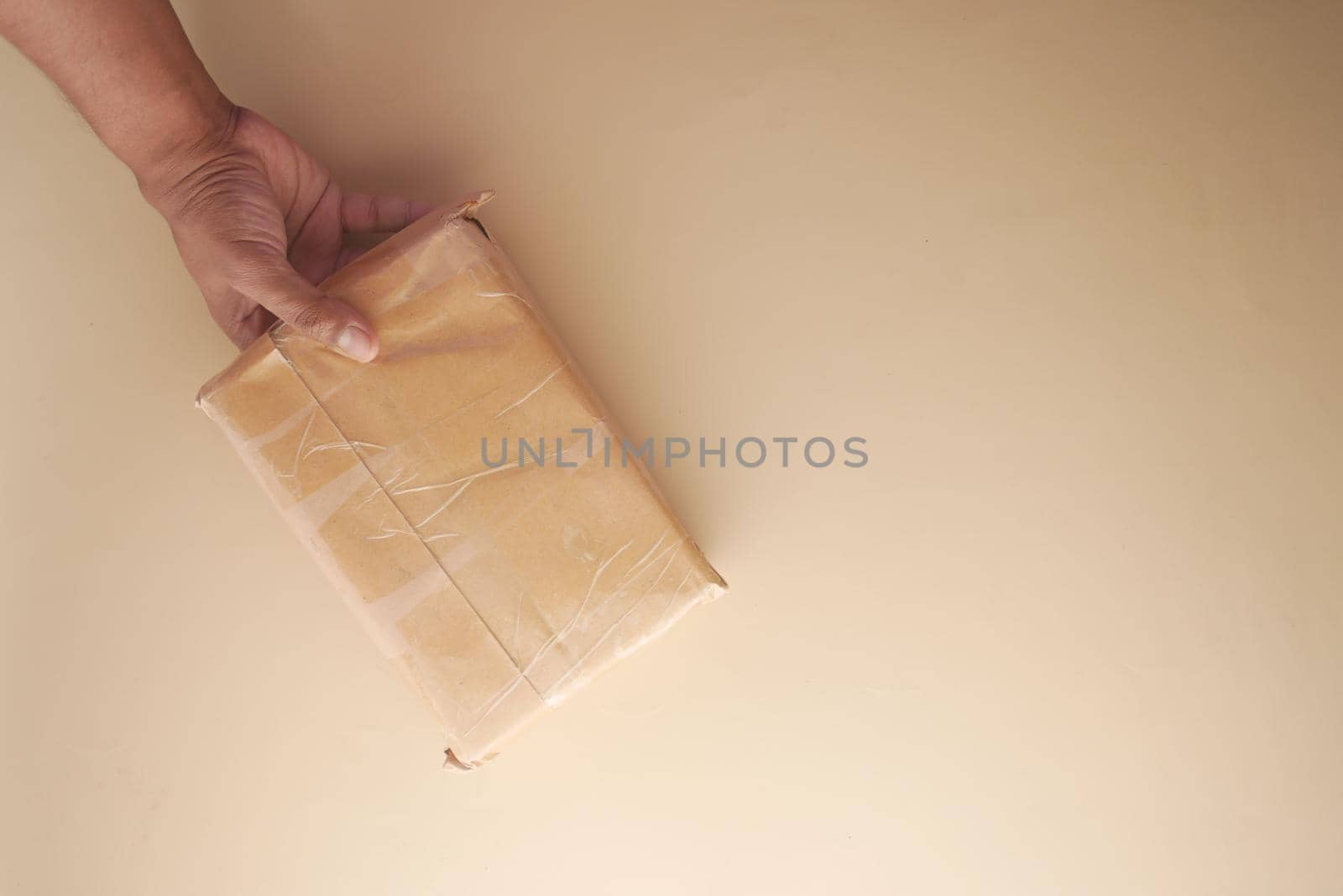 top view of hand hold a delivery box for postal ship .