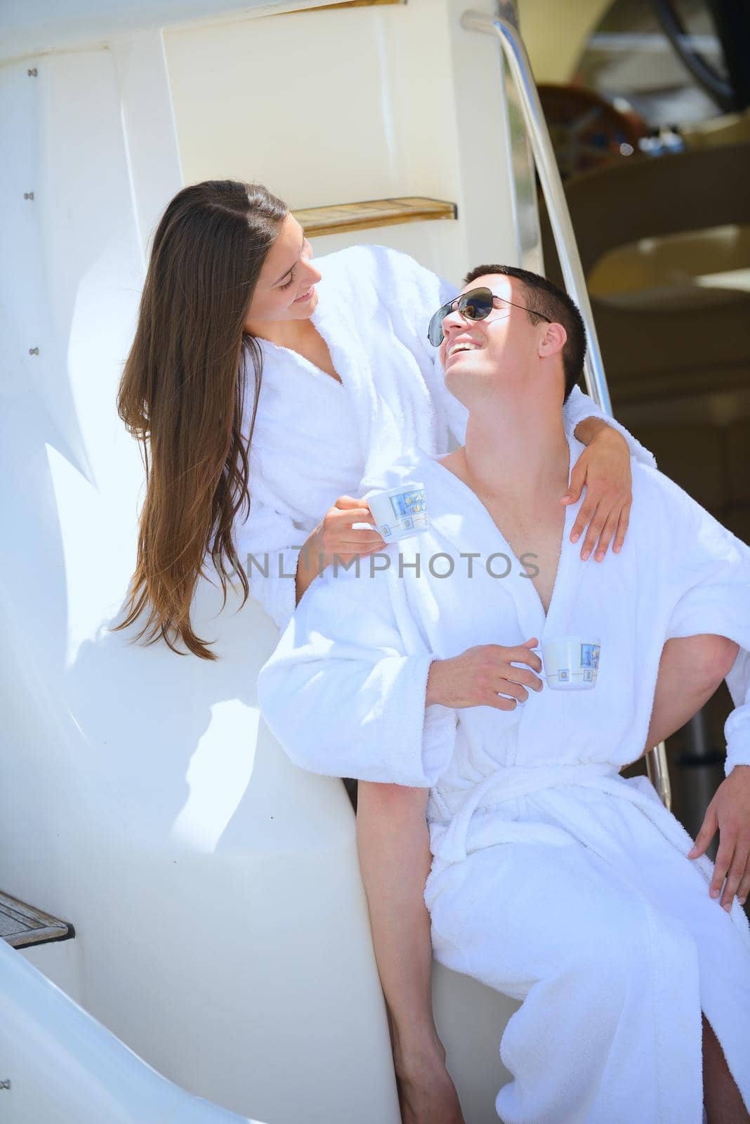 Romantic young couple spending time together and relaxing on yacht