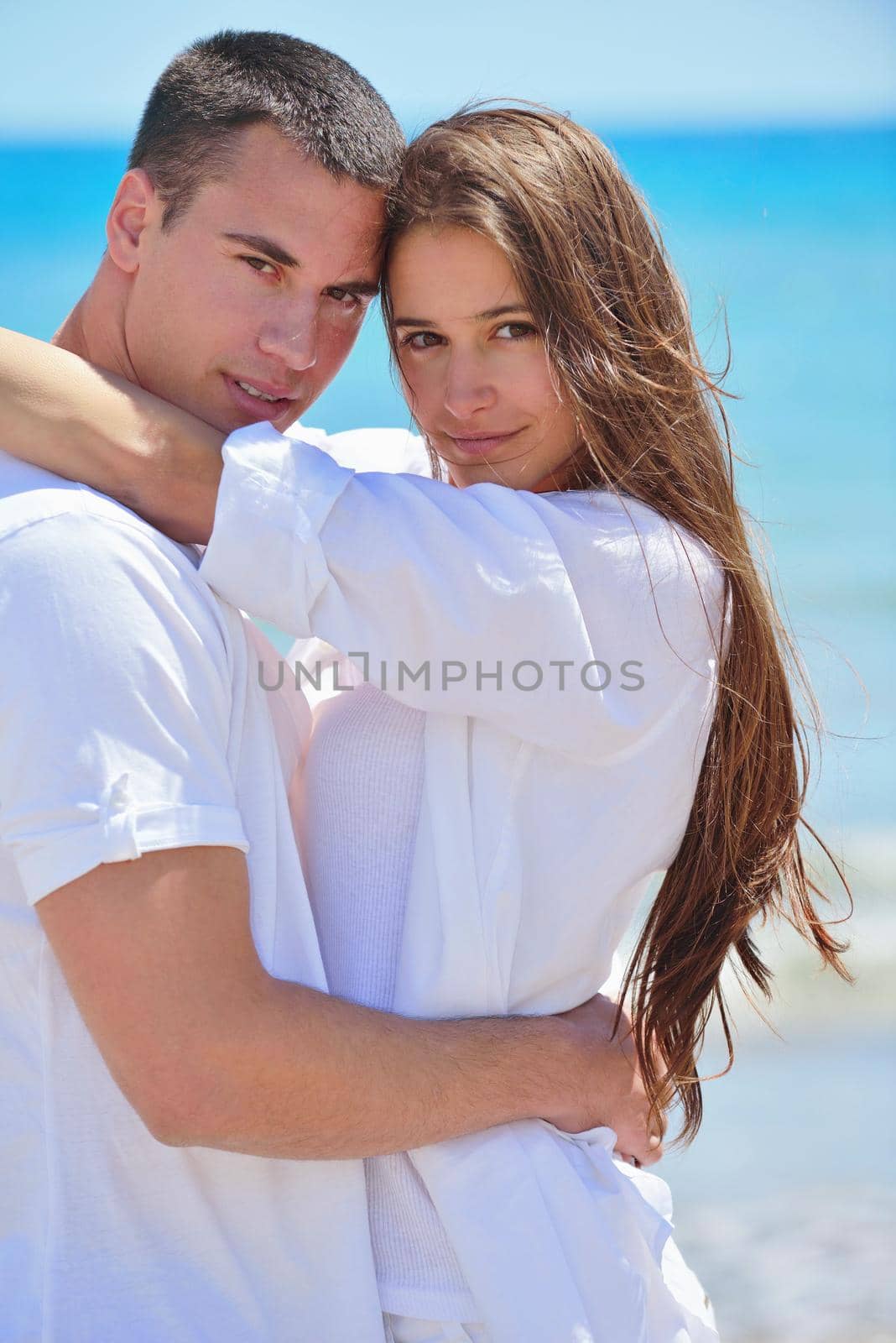 happy young couple have fun and relax  on the beach