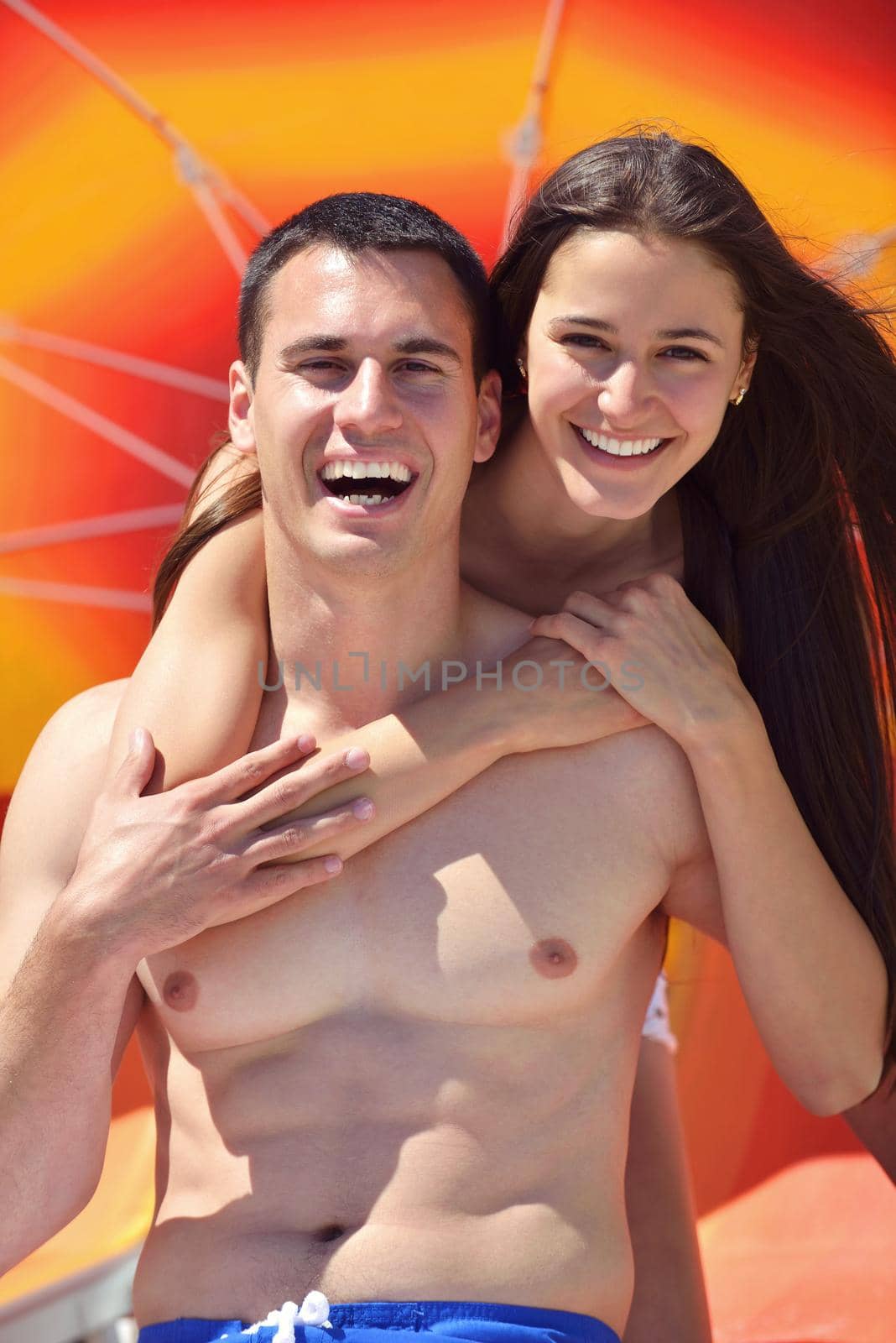 happy young couple have fun and relax  on the beach