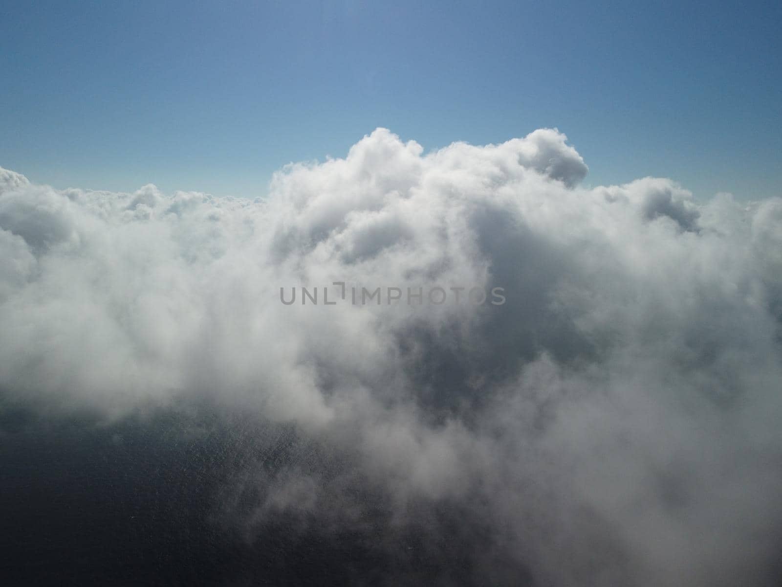 Footage B roll Aerial view drone flying above white clouds dense fog move quickly. Drone flies high back in blue sky through fluffy clouds. Beautiful foggy and cloudy slow moving Aerial view. Fog sea.