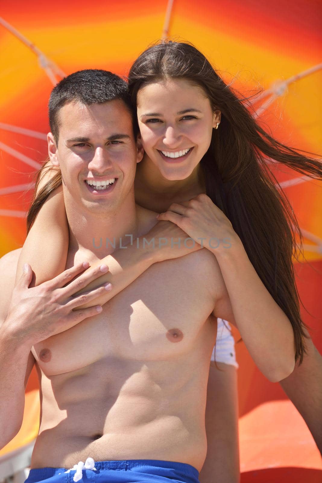 happy young couple have fun and relax  on the beach