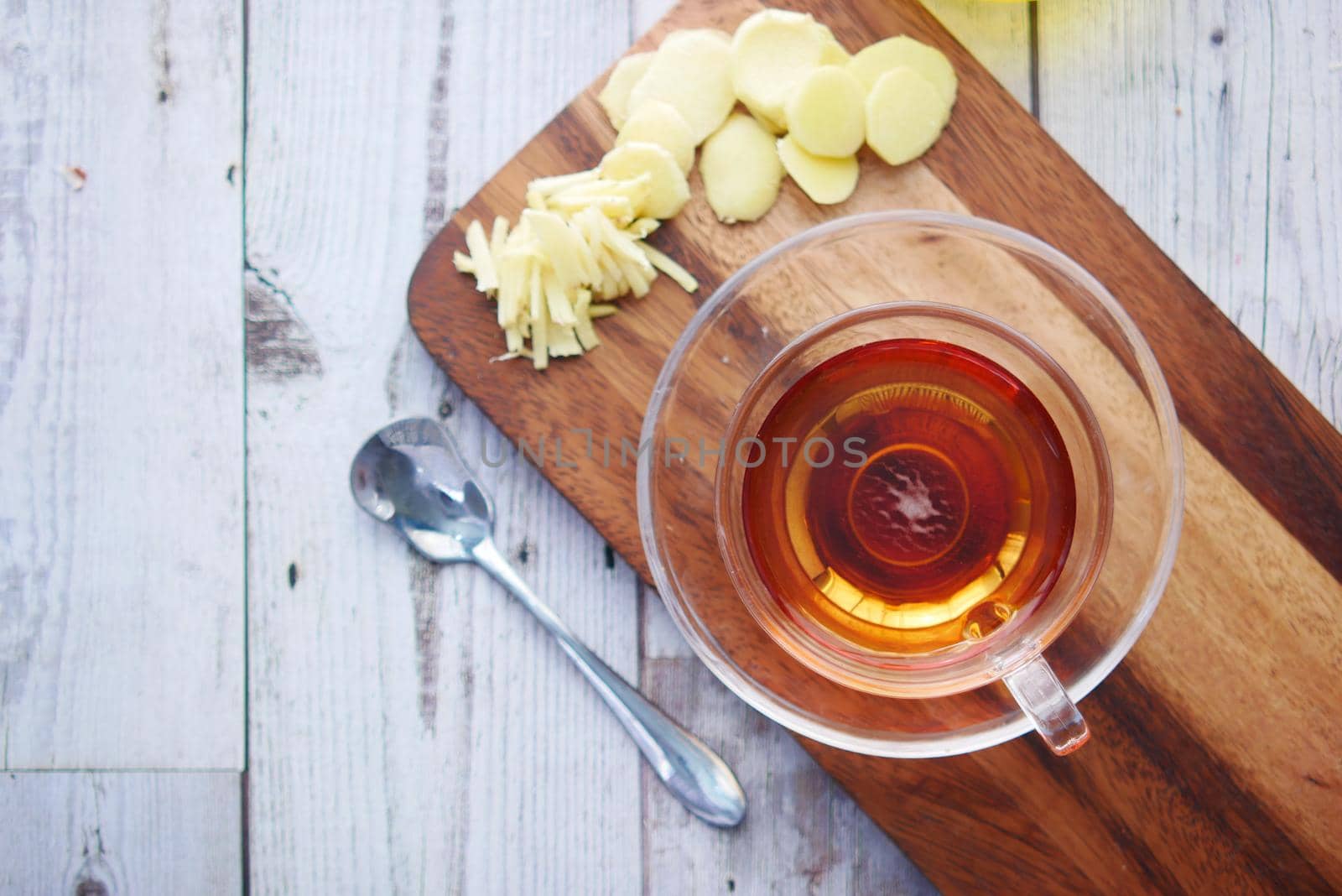 Top view of ginger tea on wooden background..