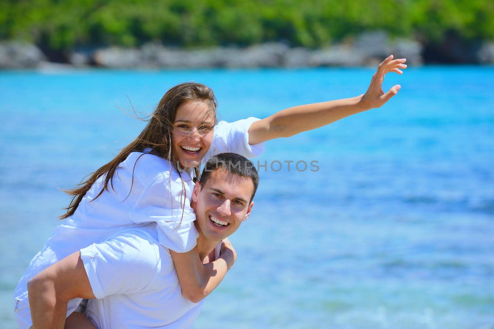 happy young couple have fun and relax  on the beach
