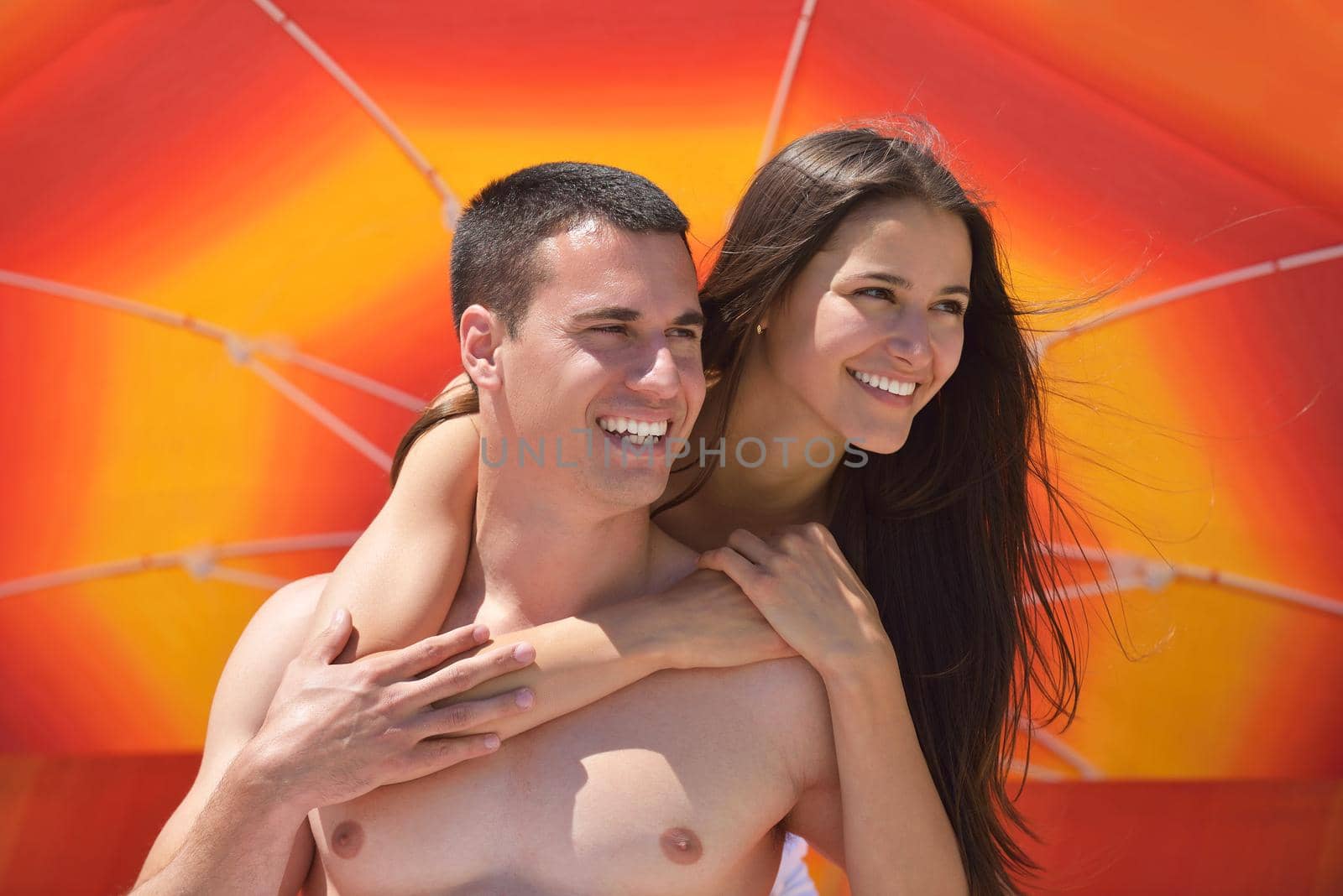 happy young couple have fun and relax  on the beach