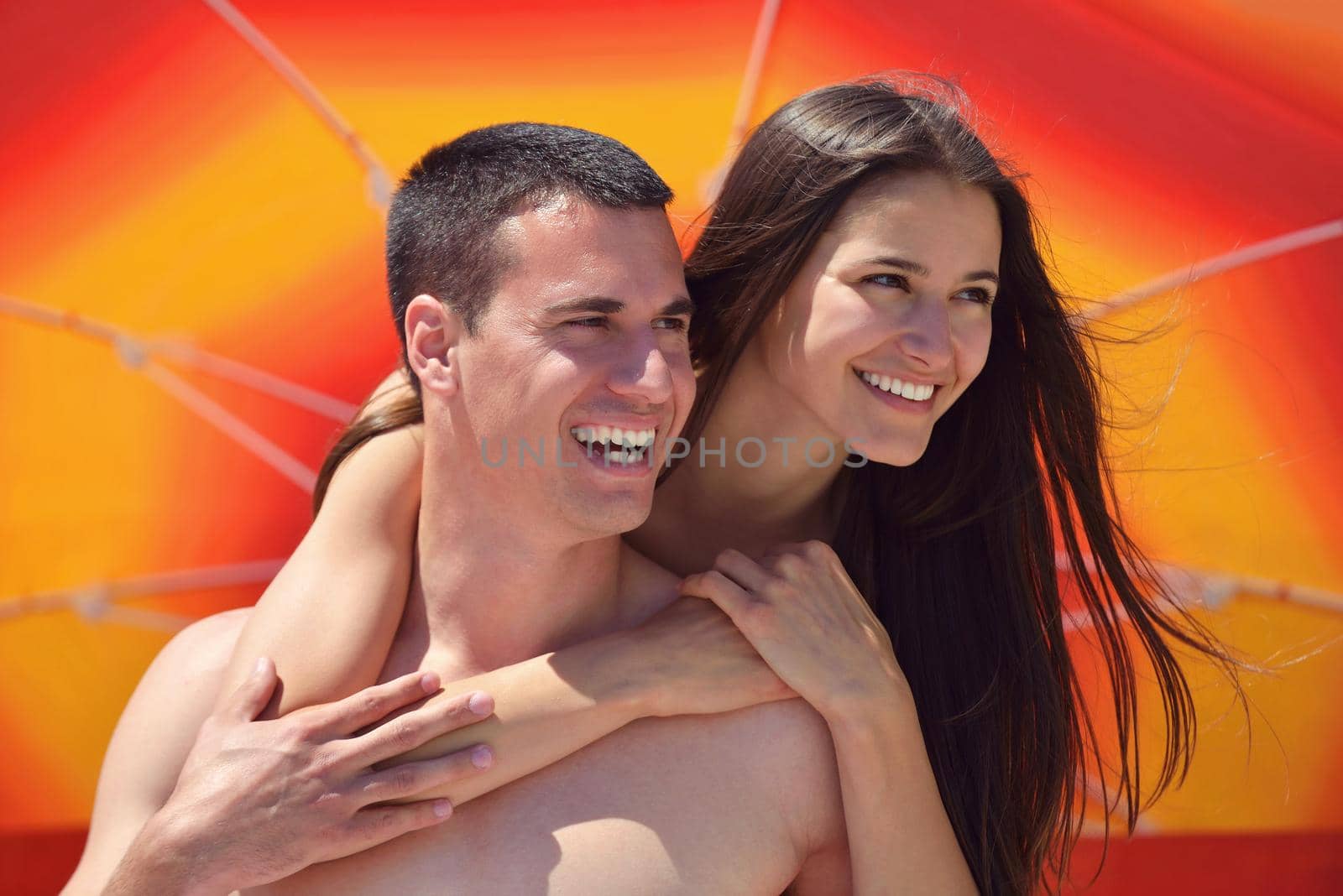 happy young couple have fun and relax  on the beach