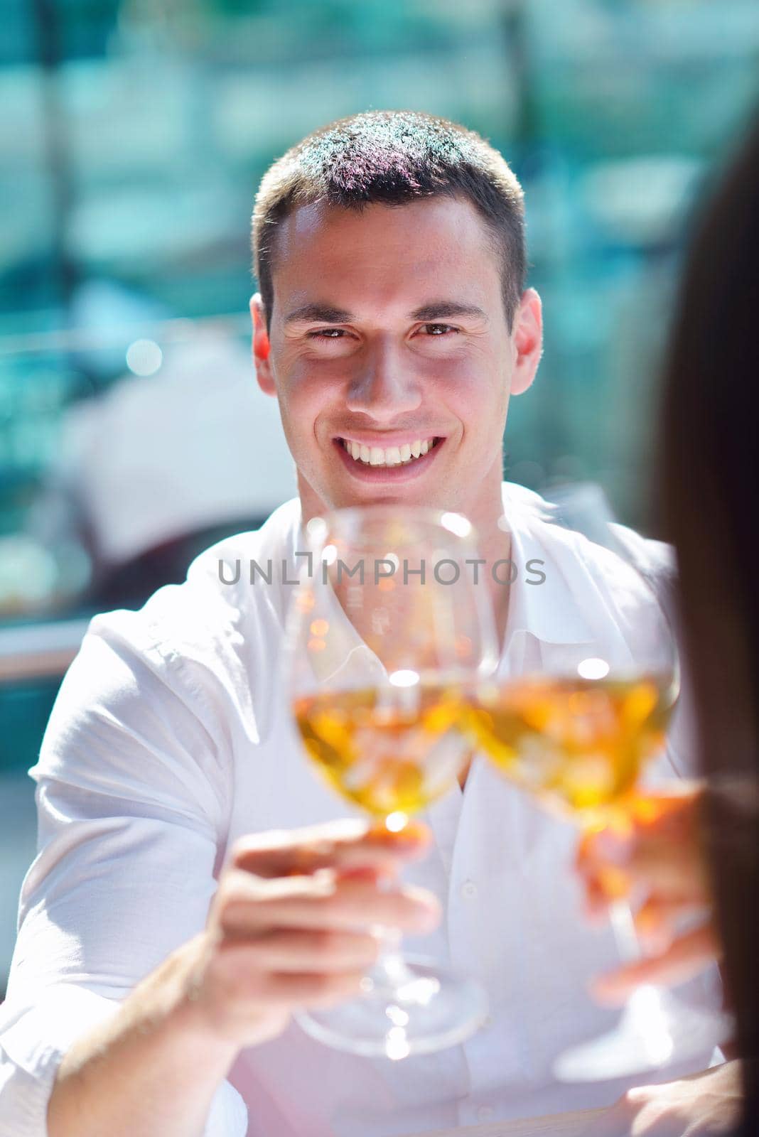 happy young couple having lanch at beautiful restaurant on by the sea on  beach