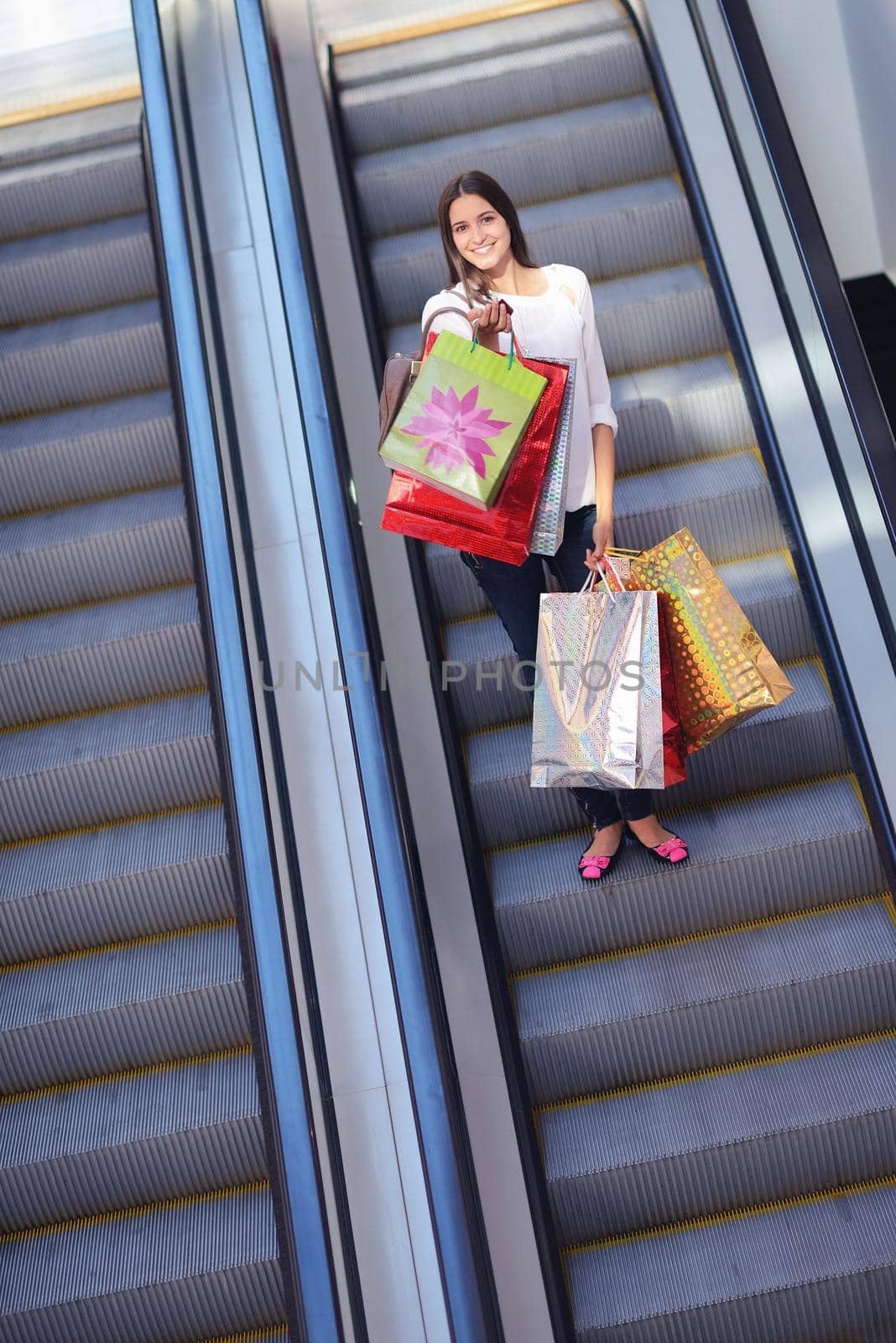 Happy young woman in a shopping mall by dotshock