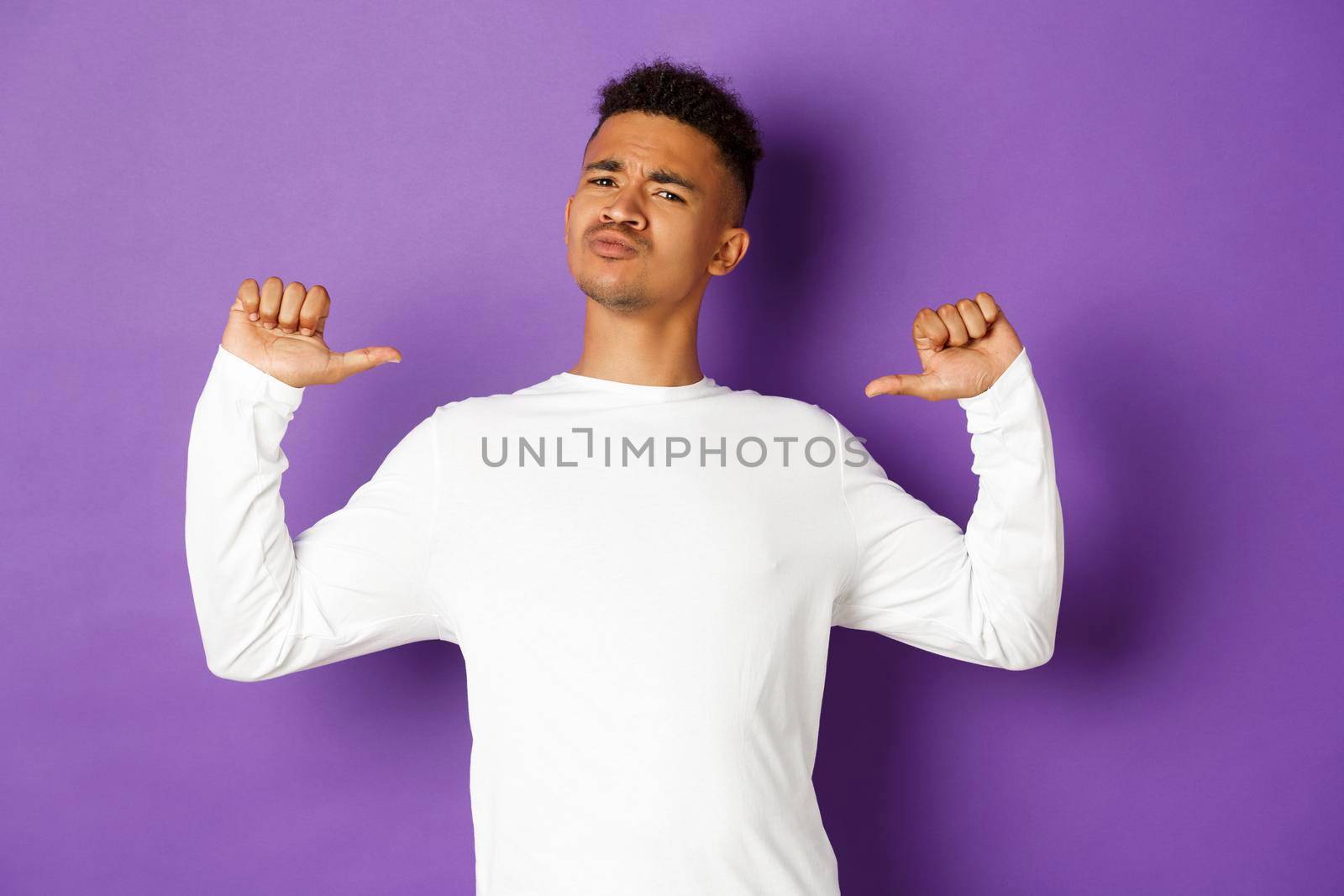 Image of confident and handsome african-american man, pointing at himself with proud face, standing self-assured over purple background by Benzoix