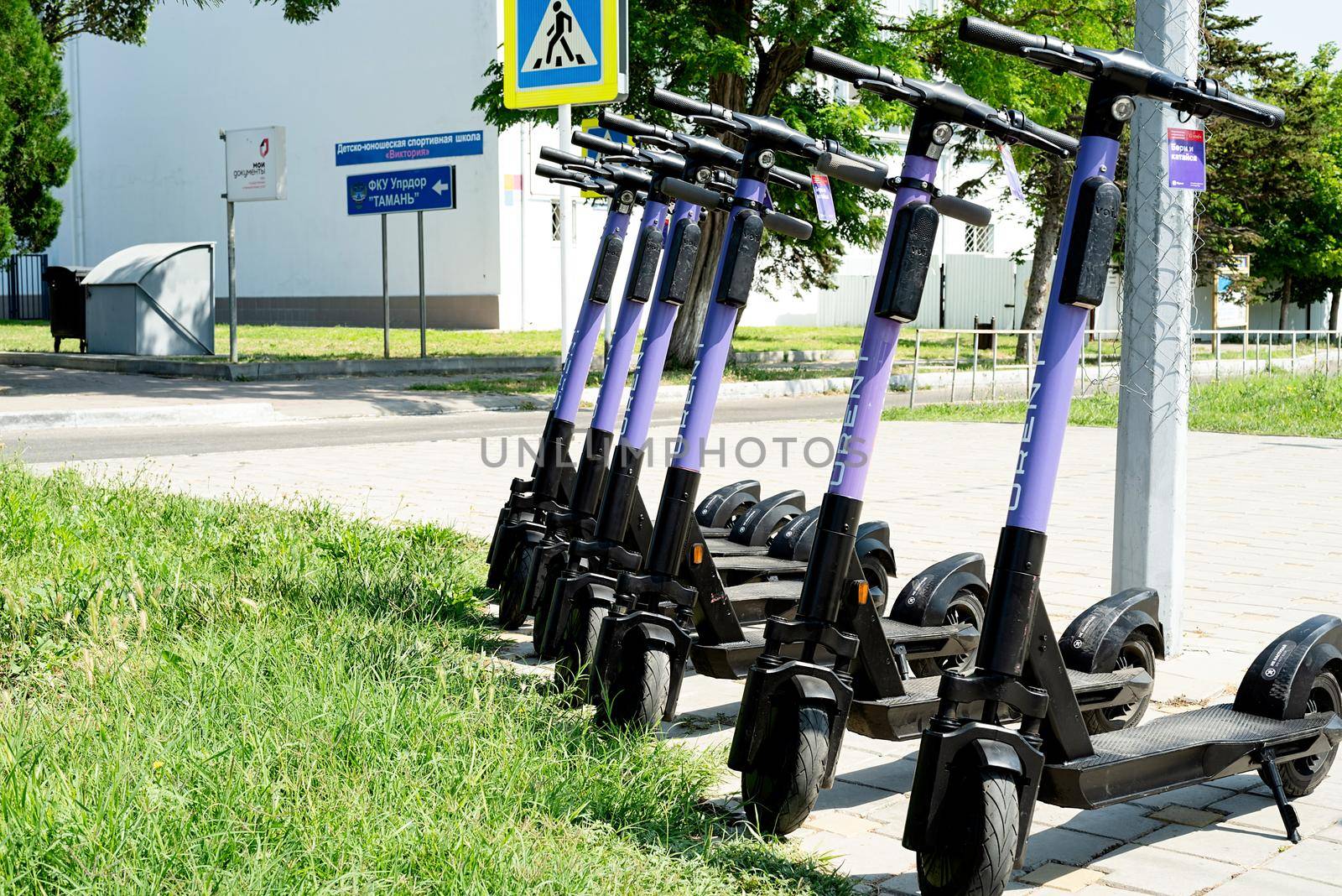 Anapa, Russia - 24 July 2021: URent electric scooters in a row on a parking by Desperada