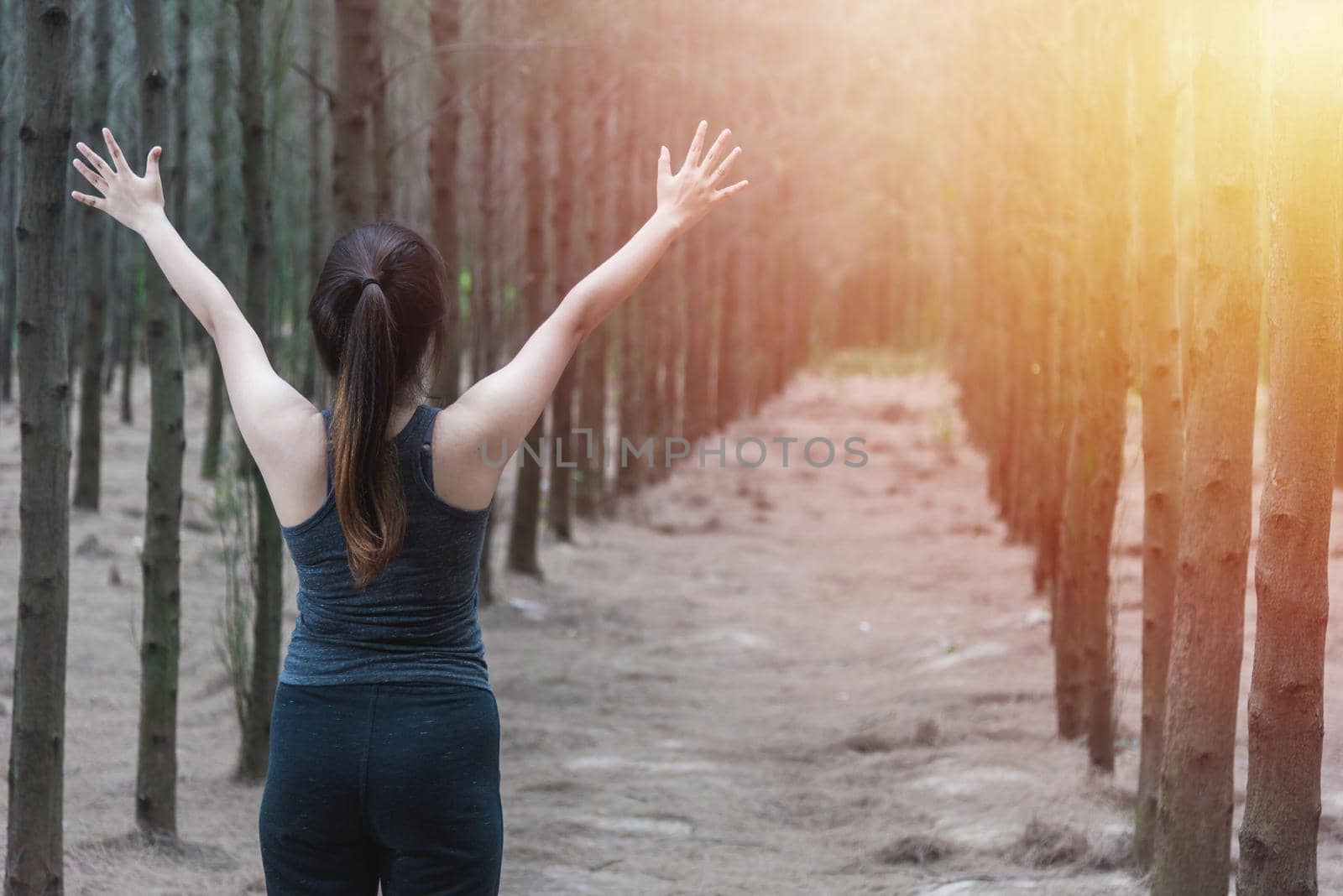 Beautiful young woman lifestyle enjoying fresh air happy relaxing in green forest park