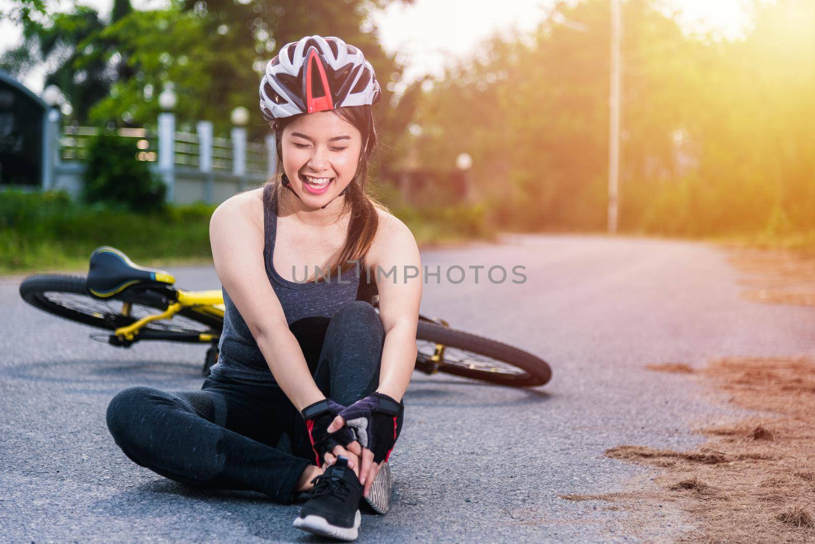 Beautiful young female woman pain injured accident sitting after bicycle falling with copy space