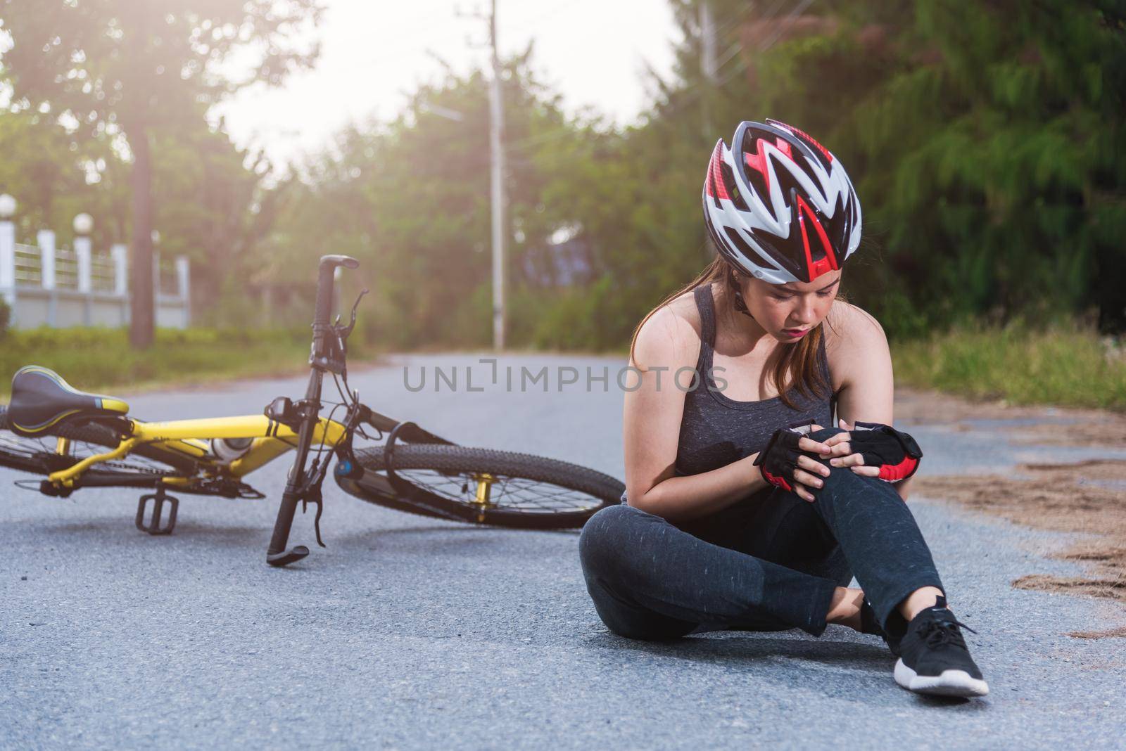 Beautiful young female woman pain injured accident sitting after bicycle falling with copy space