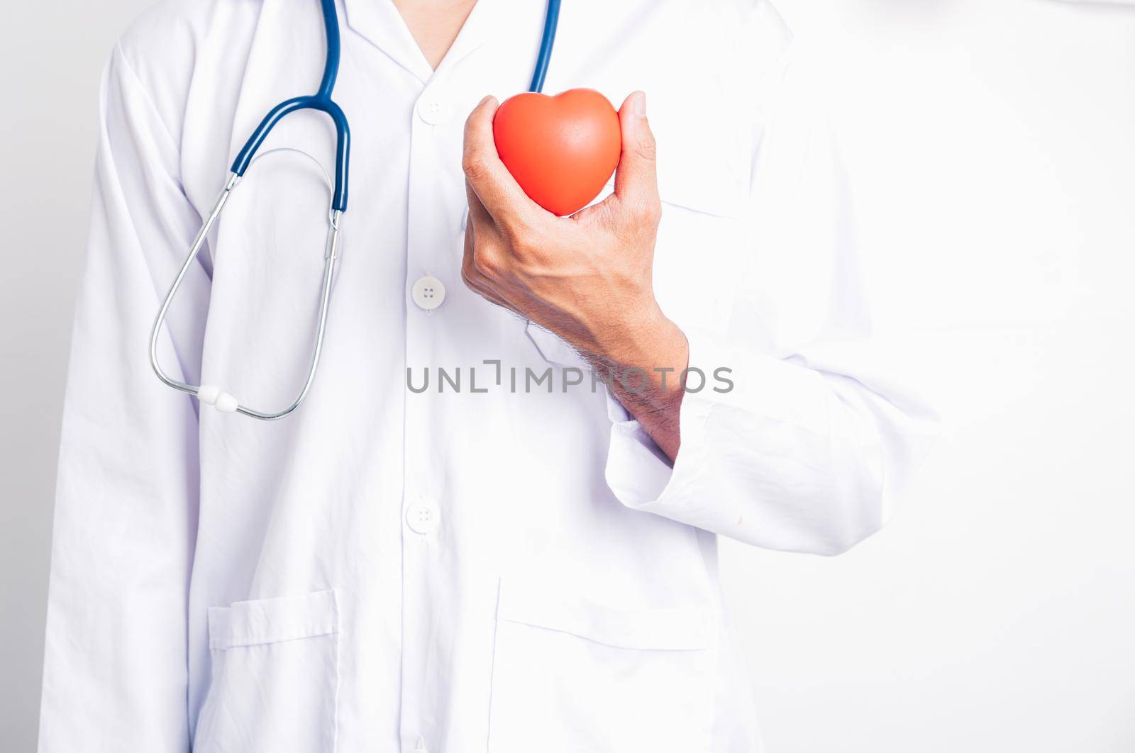 Close up Man doctor with stethoscope he is holding red heart on hand isolate on white background