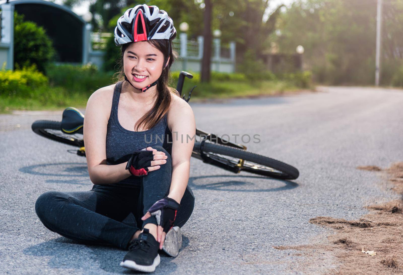 Beautiful young female woman pain injured accident sitting after bicycle falling with copy space