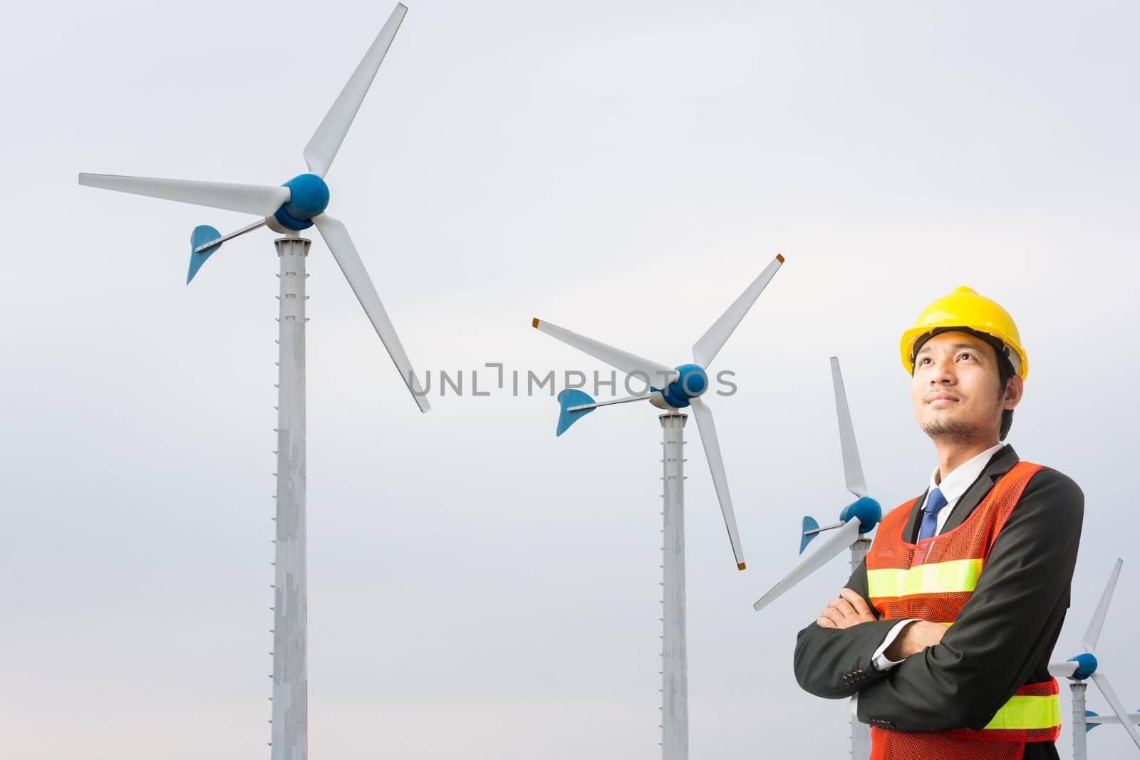 Businessmen engineering standing handsome smile front of turbine looking away