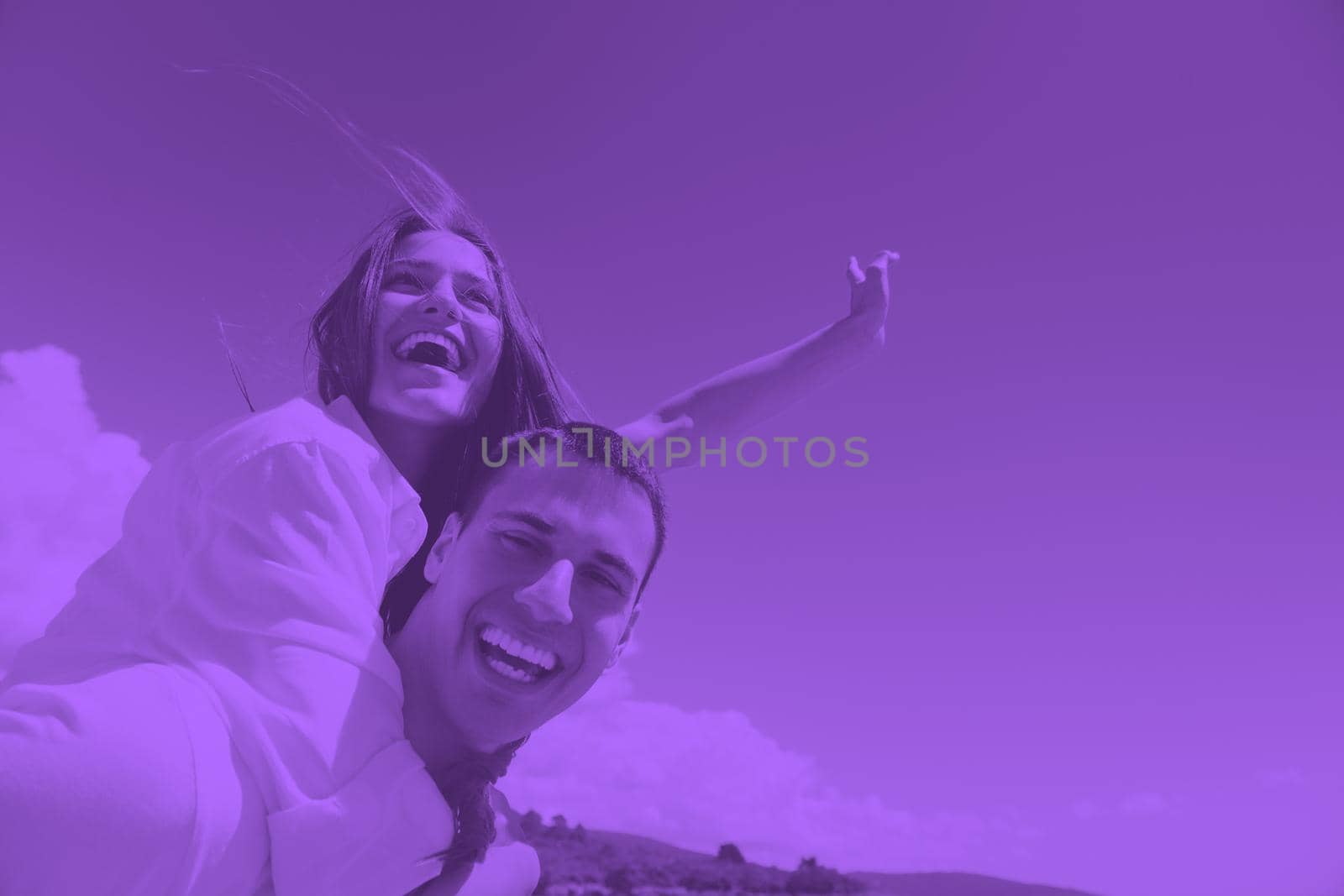 happy young couple have fun and relax  on the beach duo tone