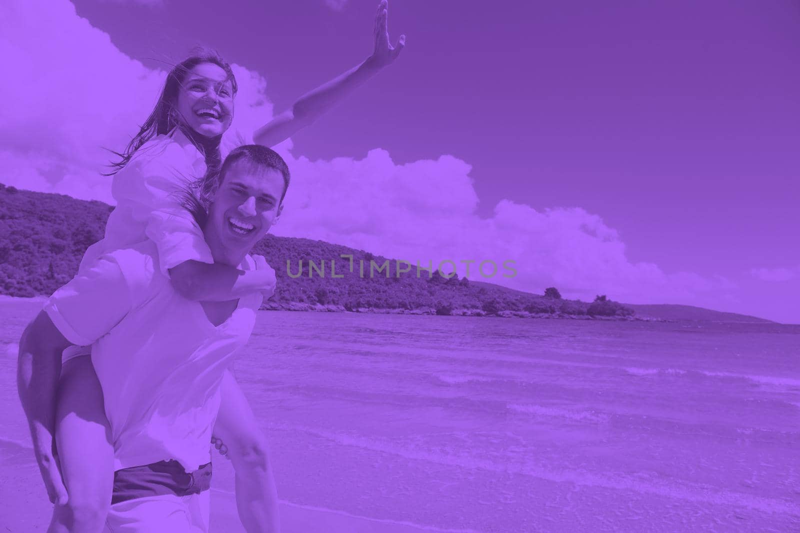happy young couple have fun and relax  on the beach duo tone