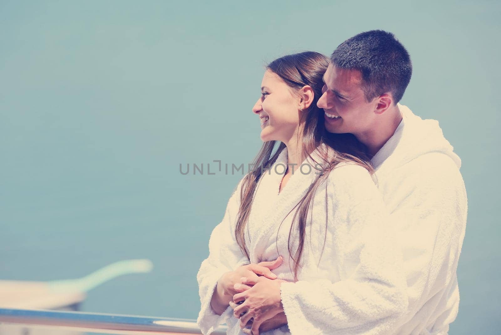 Romantic young couple spending time together and relaxing on yacht