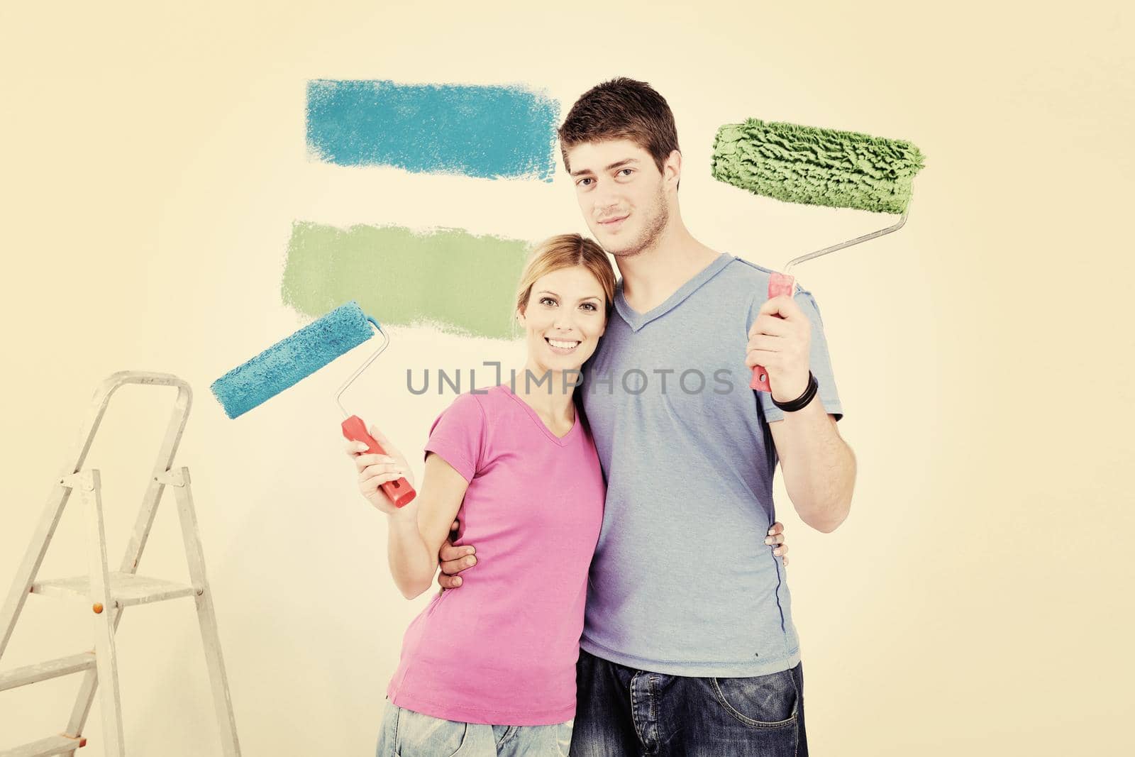 happy couple paint wall at new home by dotshock