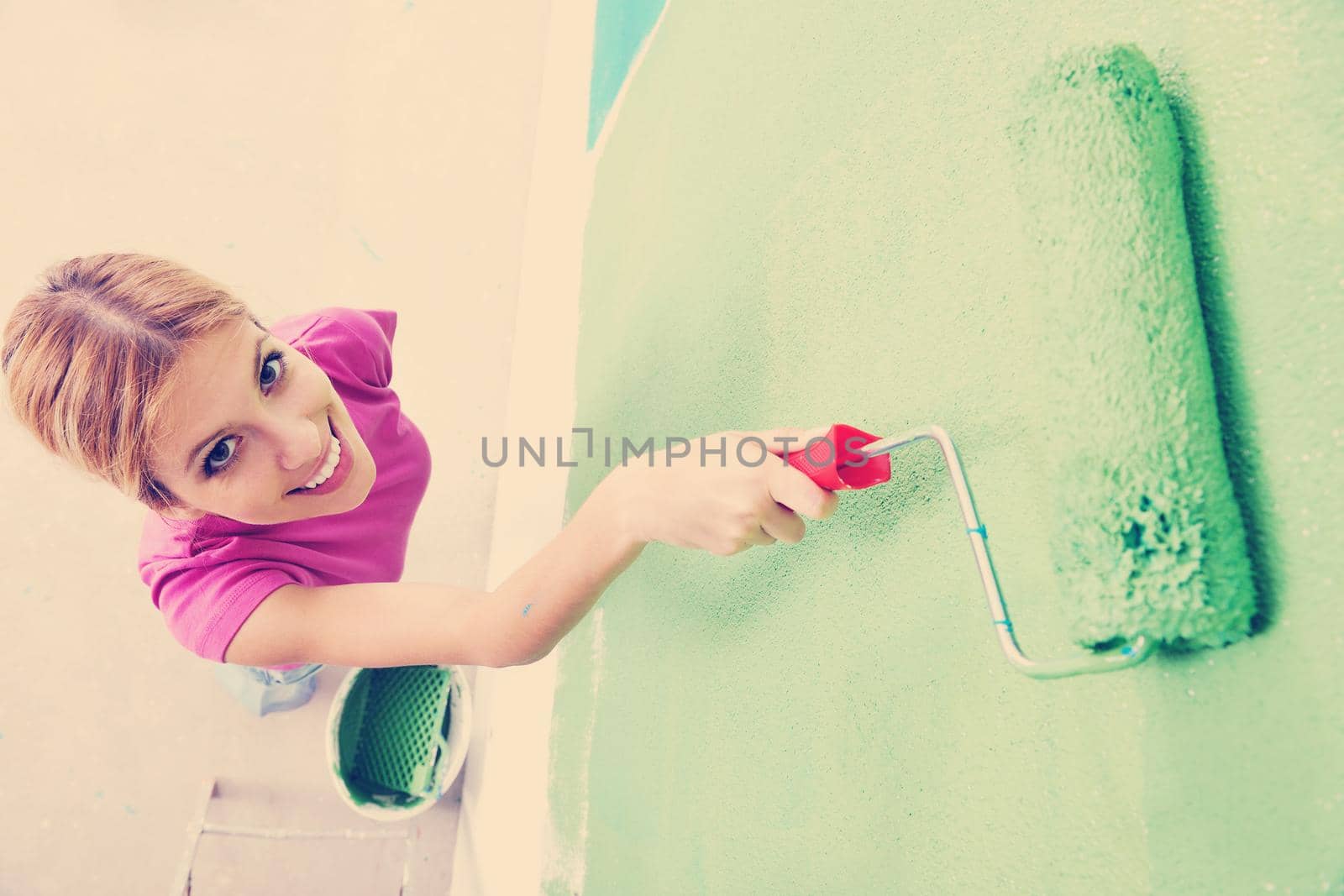 happy smiling woman painting interior of house by dotshock